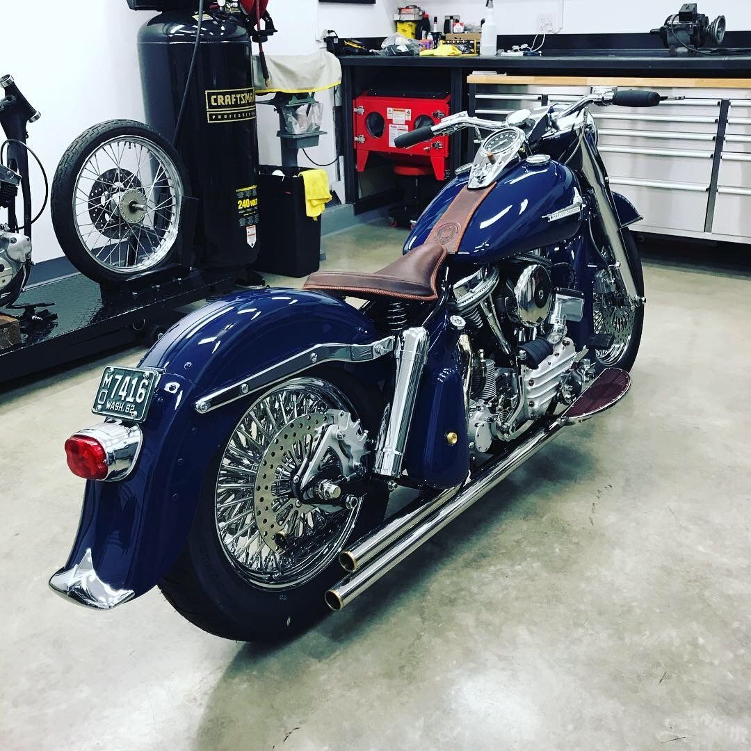 A blue harley davidson motorcycle is parked in a garage