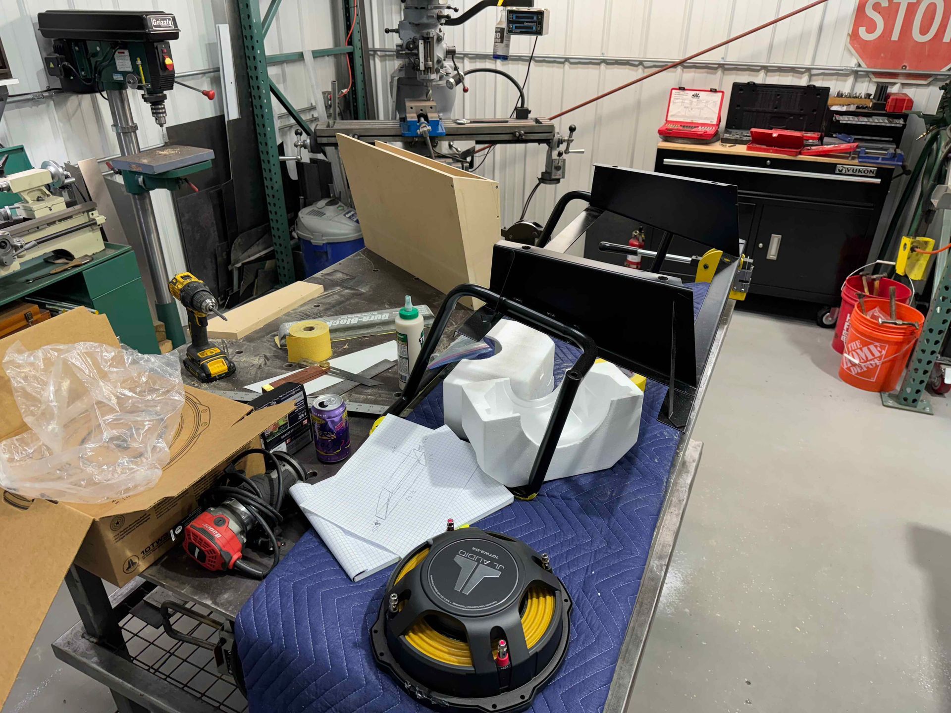 A messy workshop with a stop sign in the background.