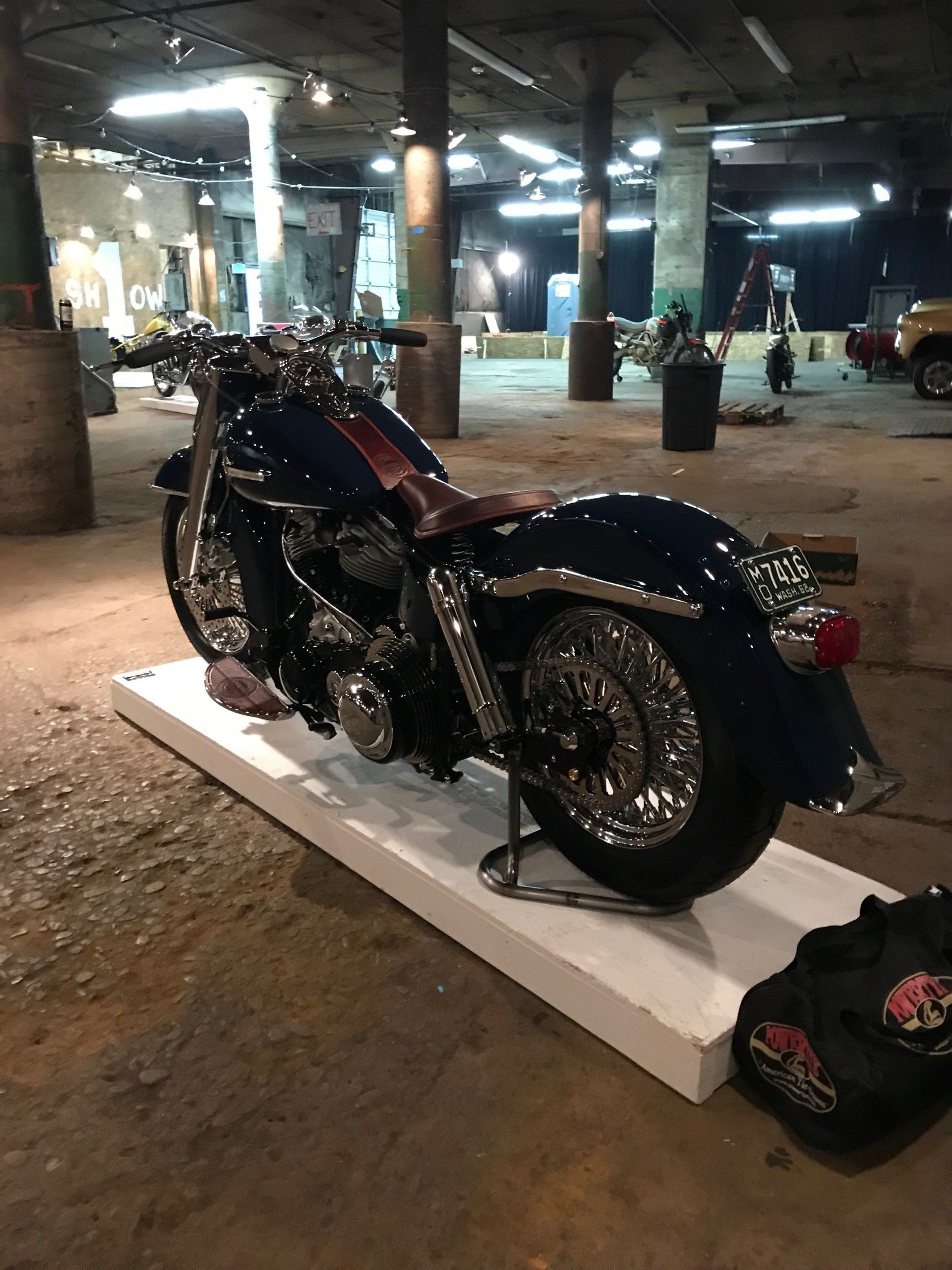 A blue harley davidson motorcycle is on display in a garage