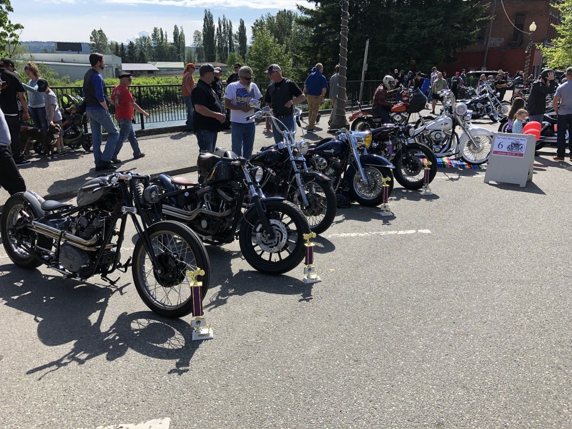 A row of motorcycles are parked in a parking lot