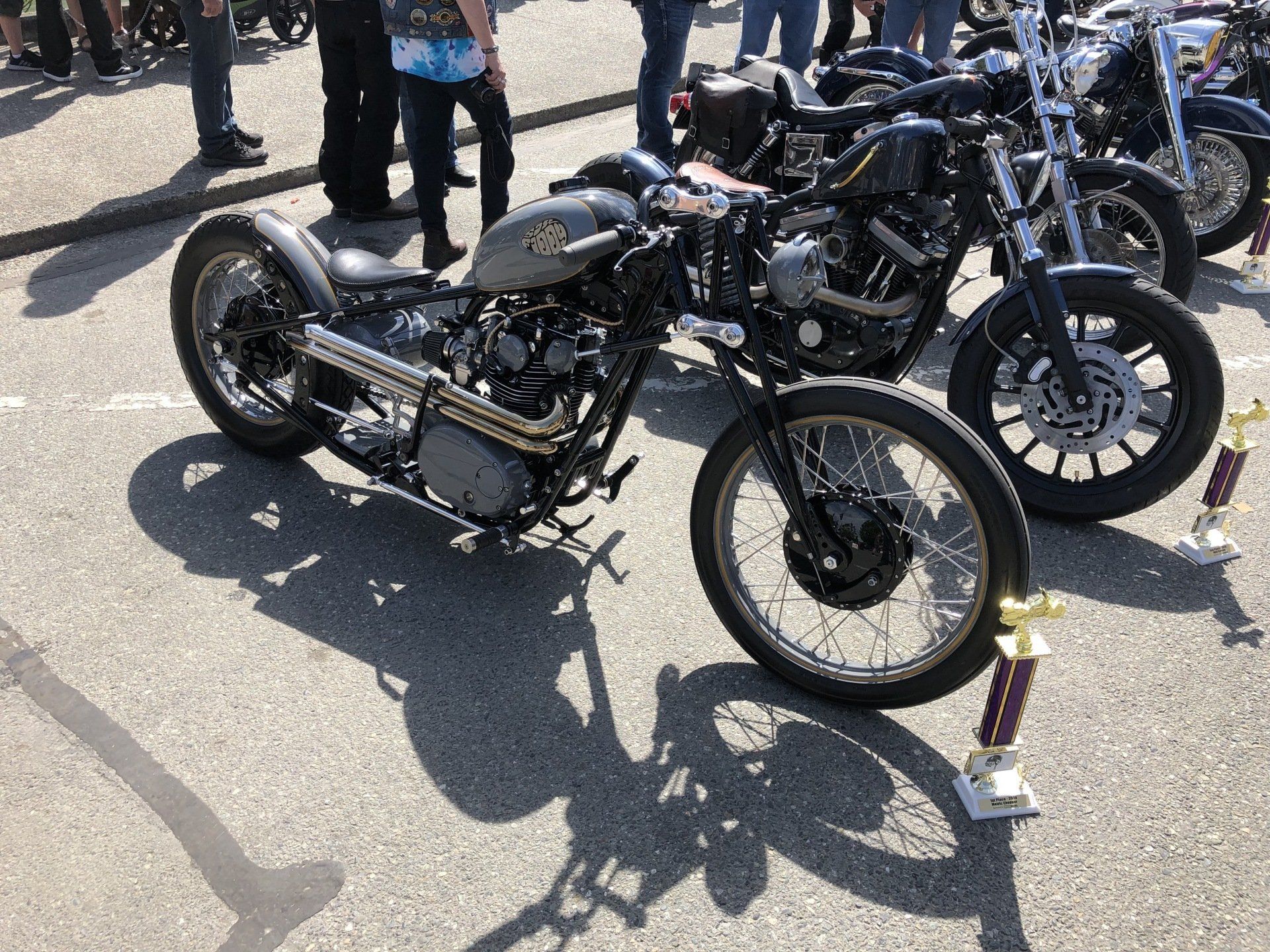 A row of motorcycles are parked on the side of the road.