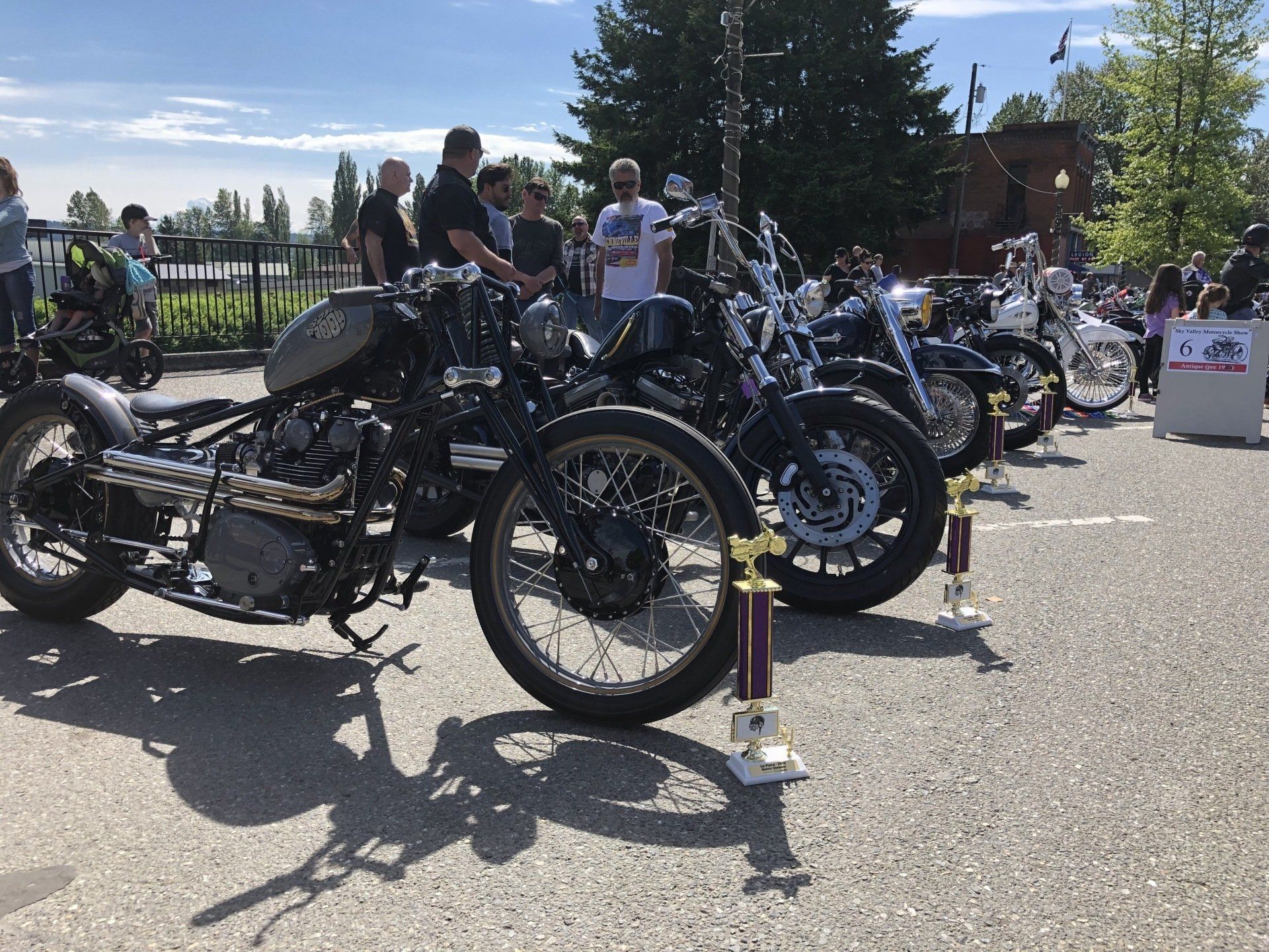 A row of motorcycles are parked in a parking lot.