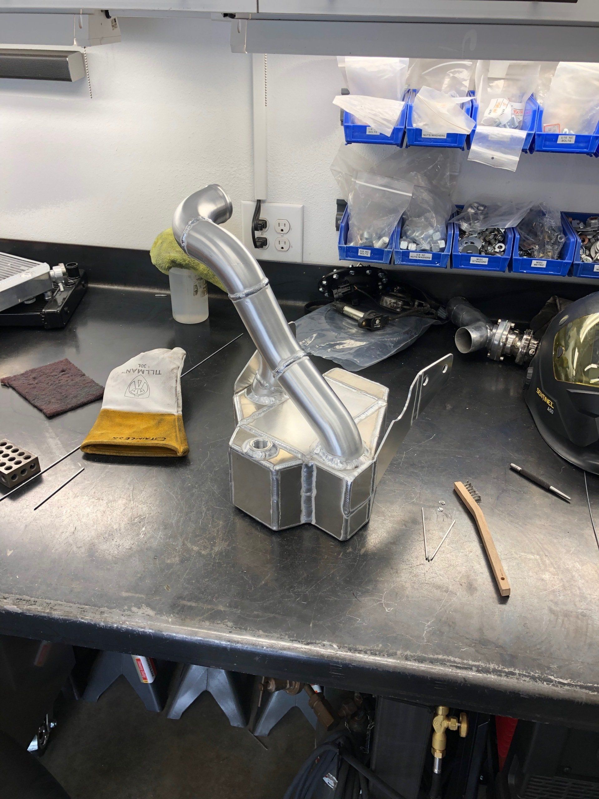 A metal object is sitting on top of a metal table