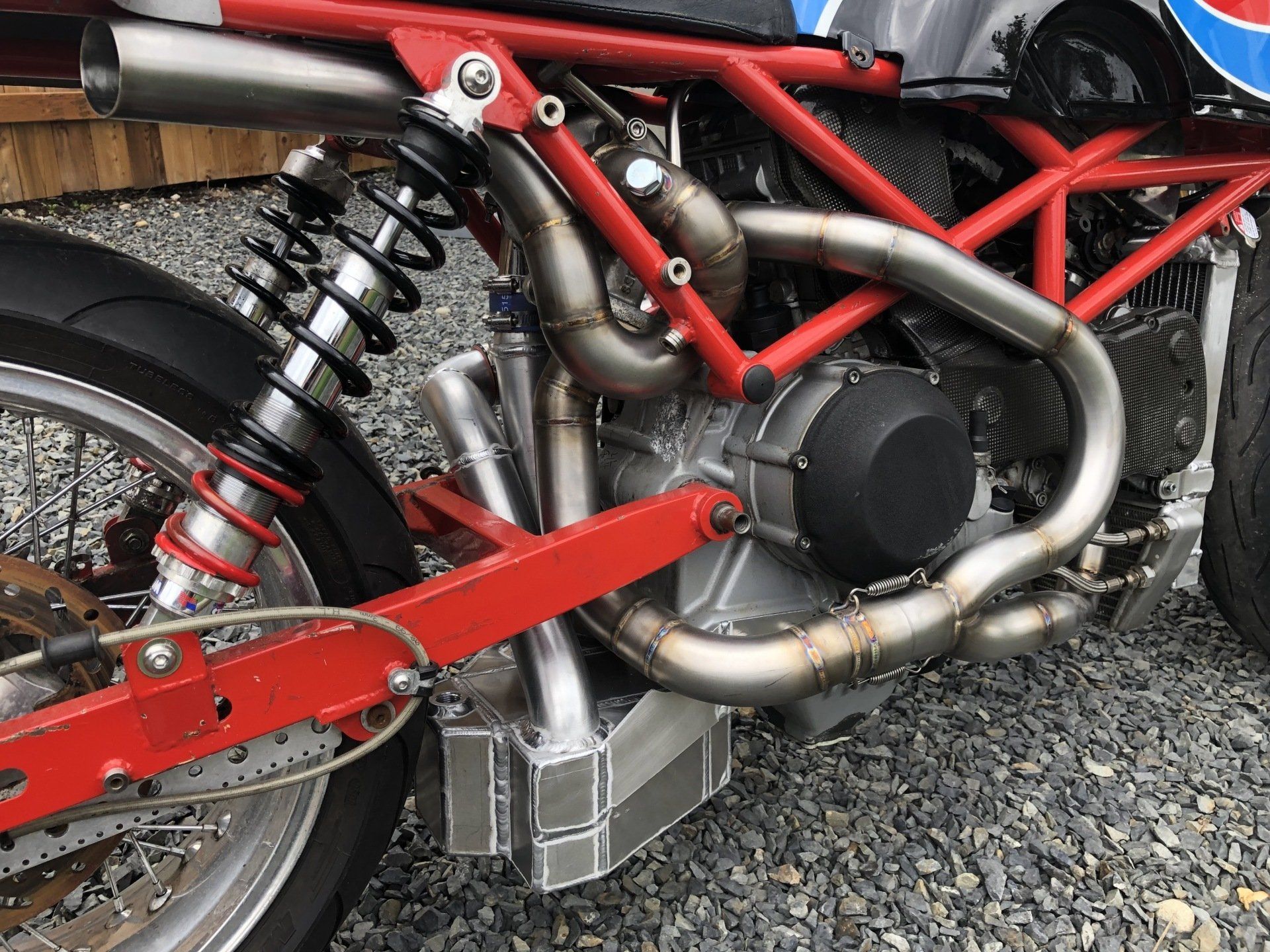 A close up of a motorcycle engine and exhaust pipes