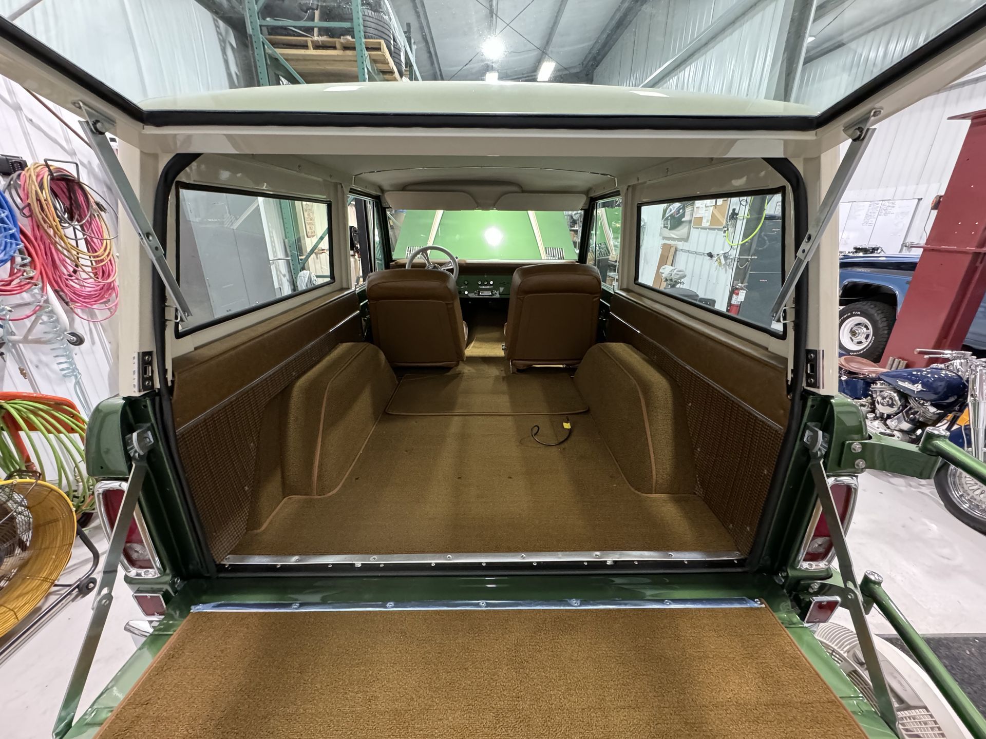 The inside of a green jeep with the door open