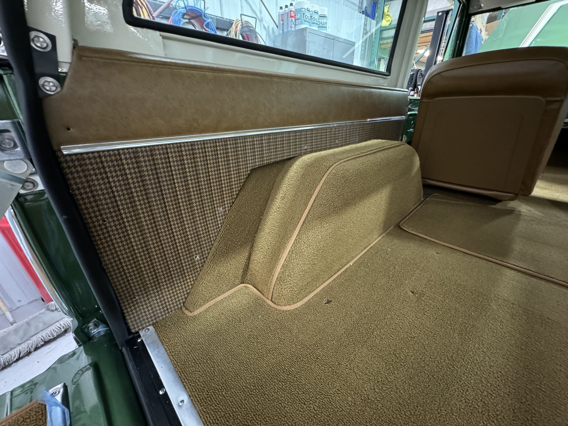 A close up of the interior of a car with a carpeted floor.