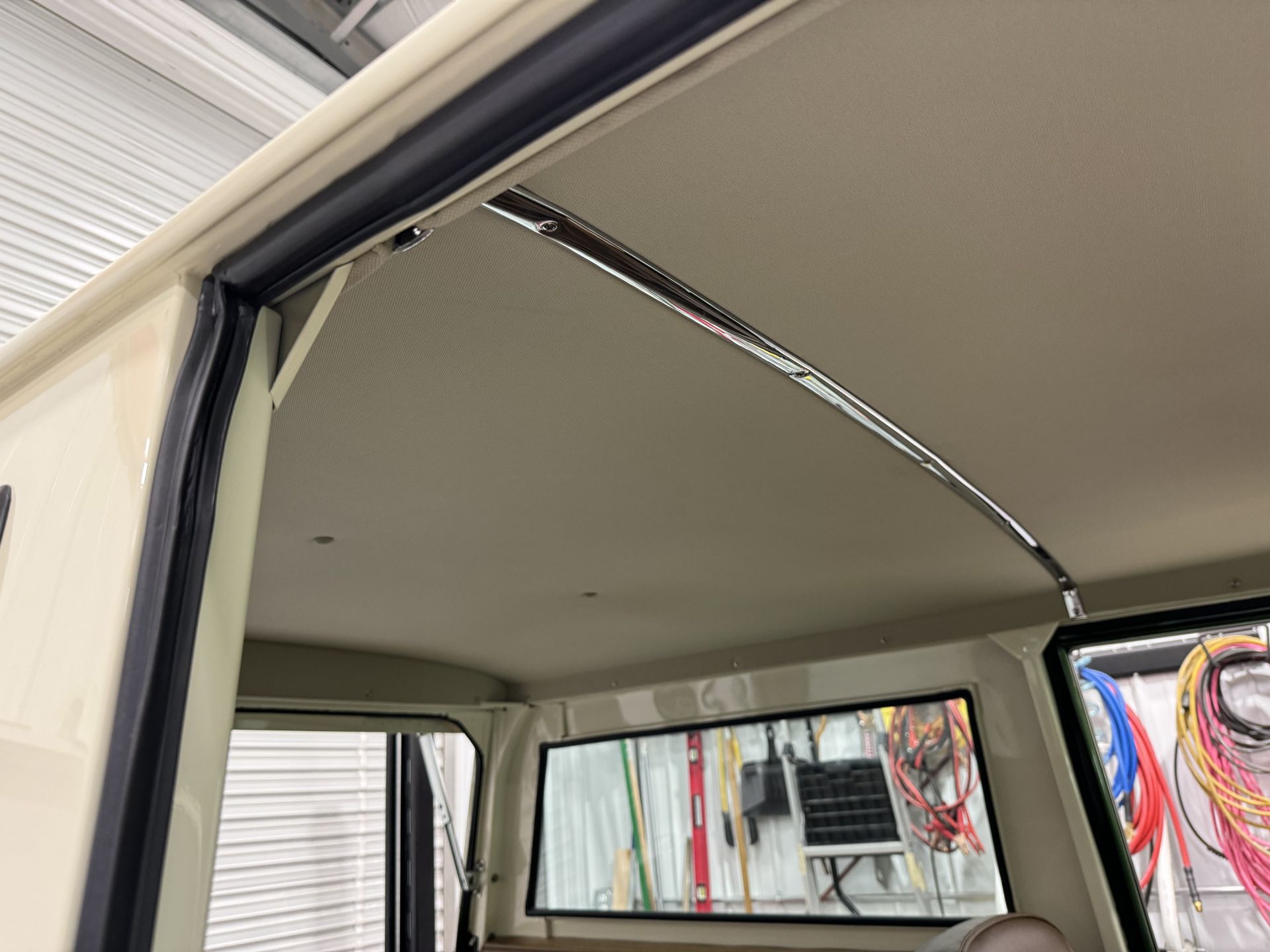 The inside of a car with a ceiling and a window.