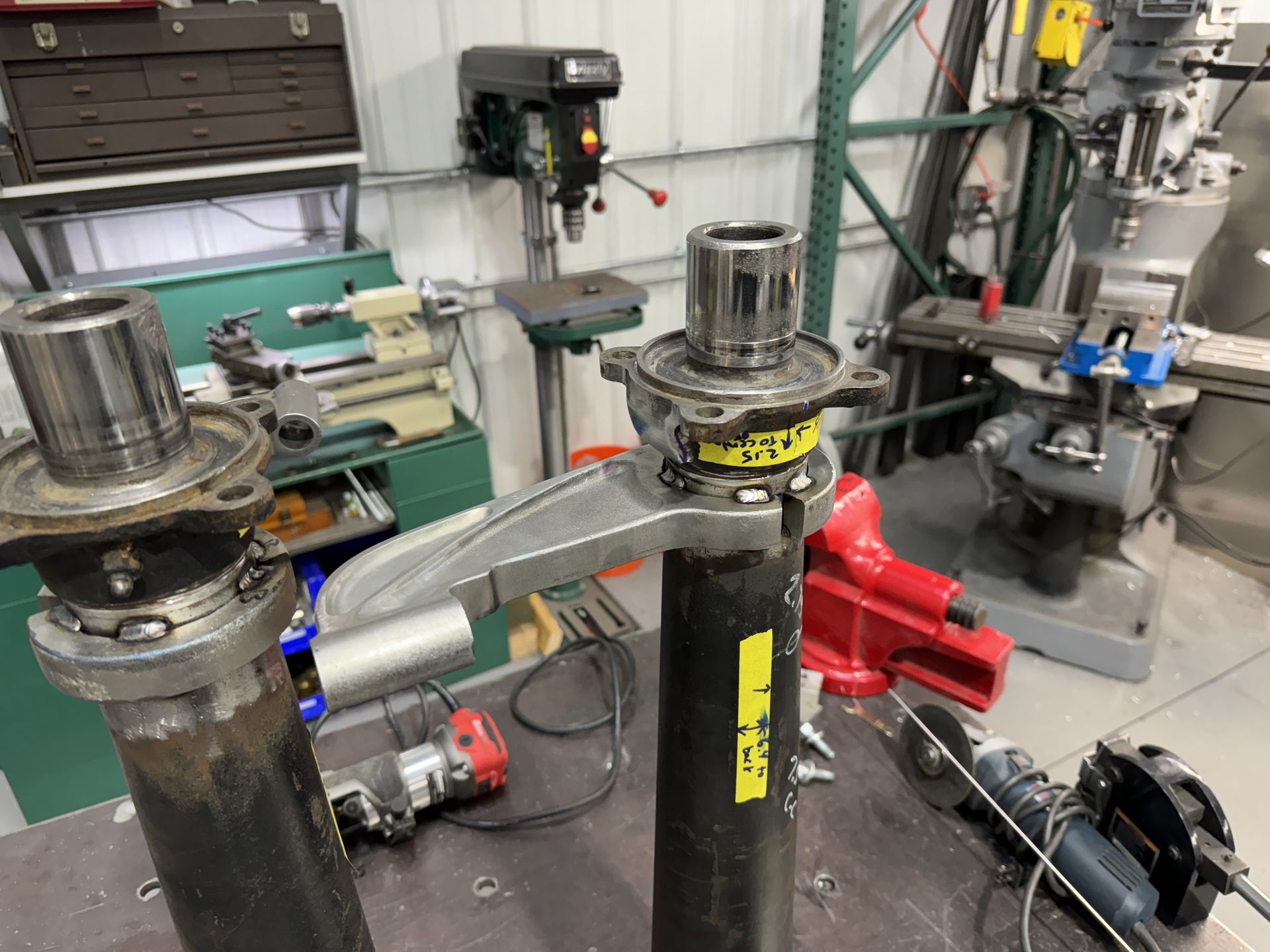 A couple of pieces of metal sitting on top of a table in a workshop.