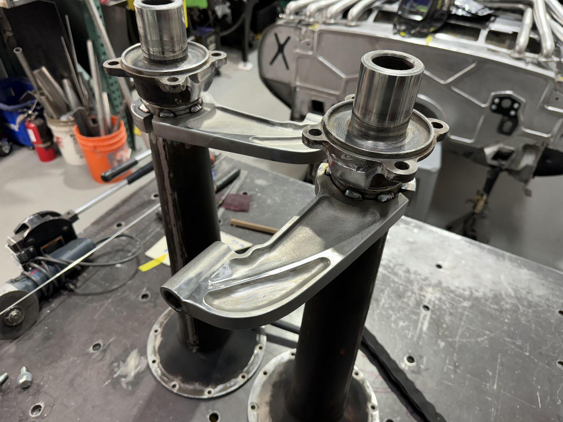 A piece of metal is sitting on top of a table in a garage.
