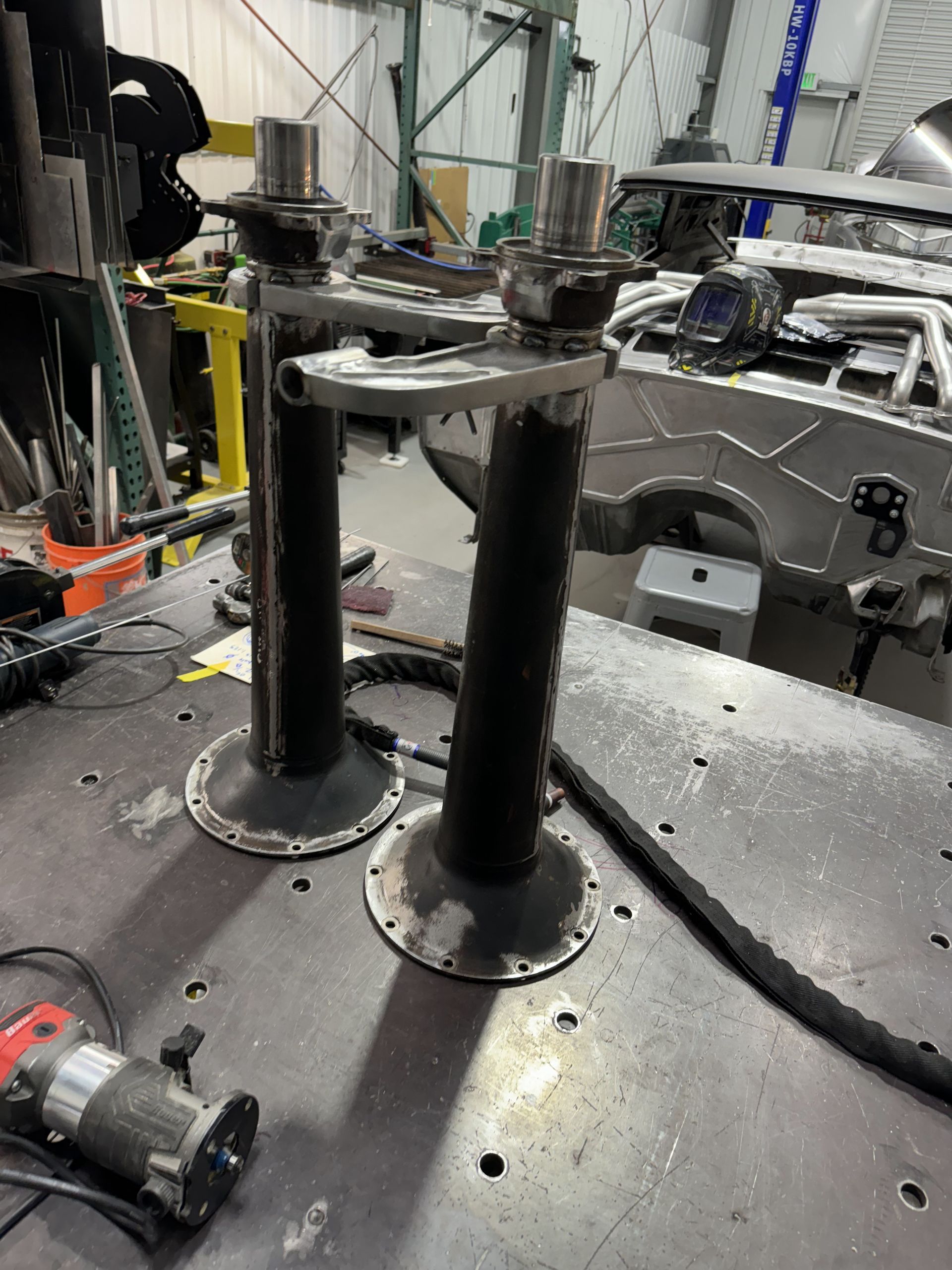 A pair of metal cylinders are sitting on top of a metal table.