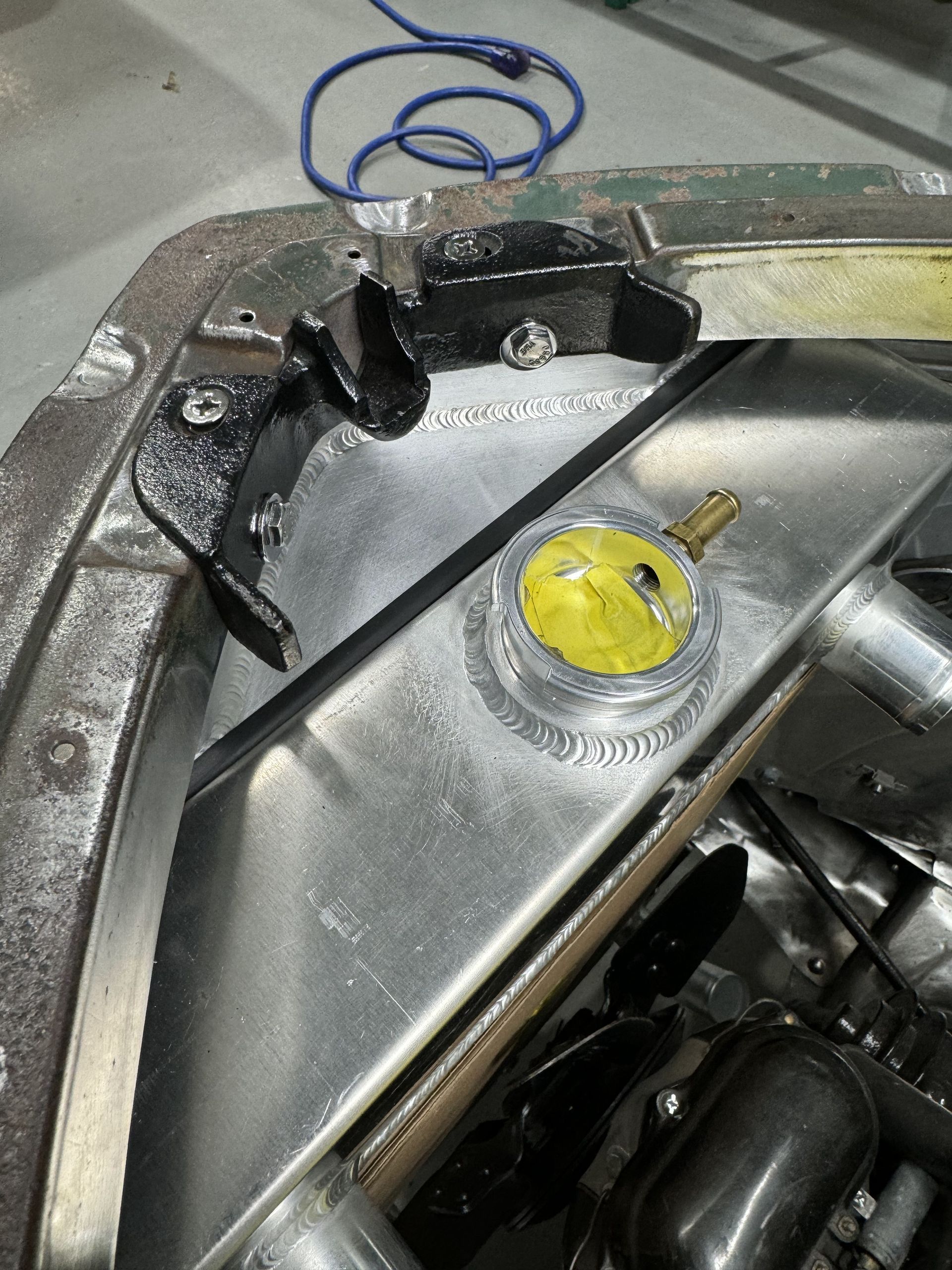 A close up of a metal object with a yellow sticker on it.