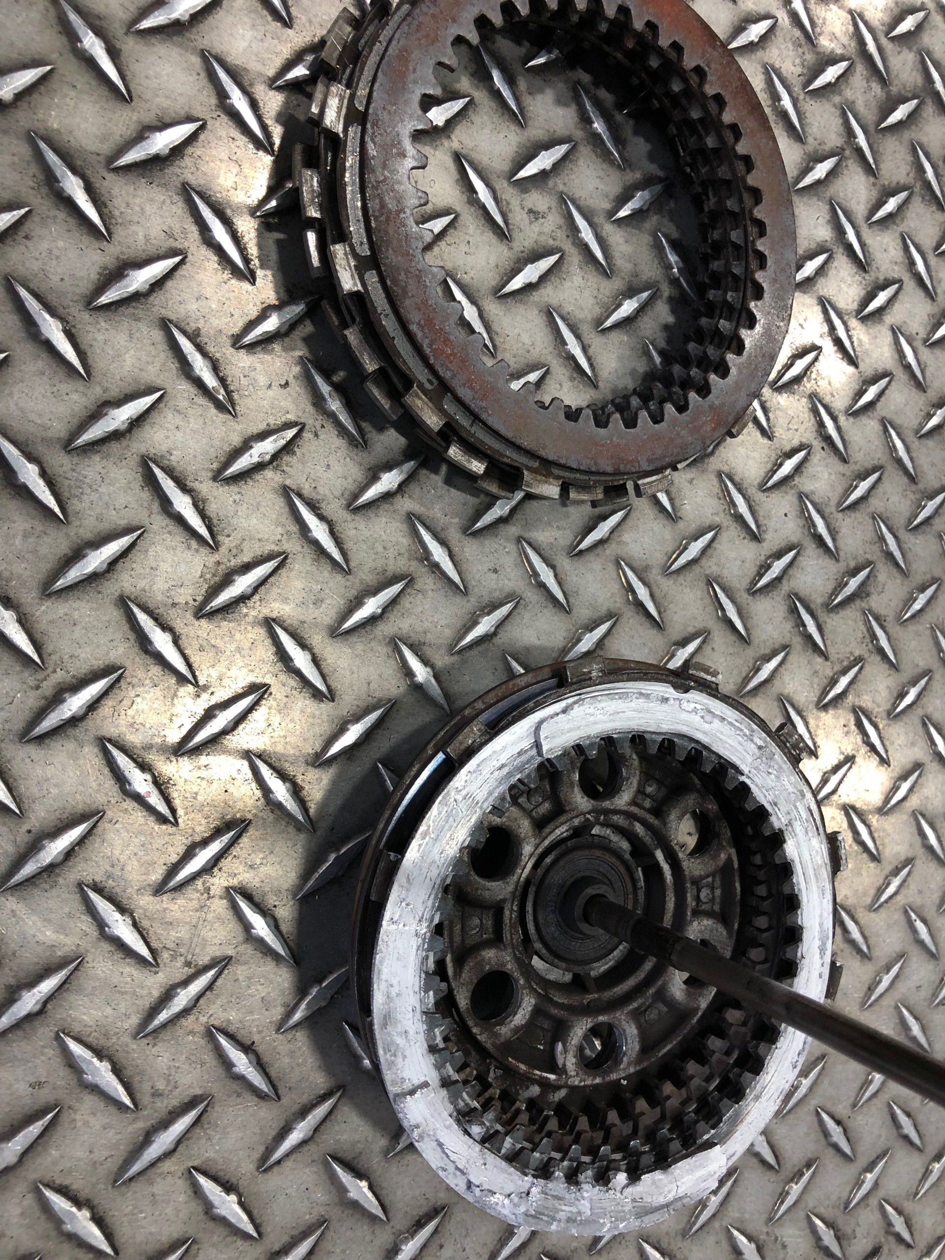 A close up of two gears on a metal surface.