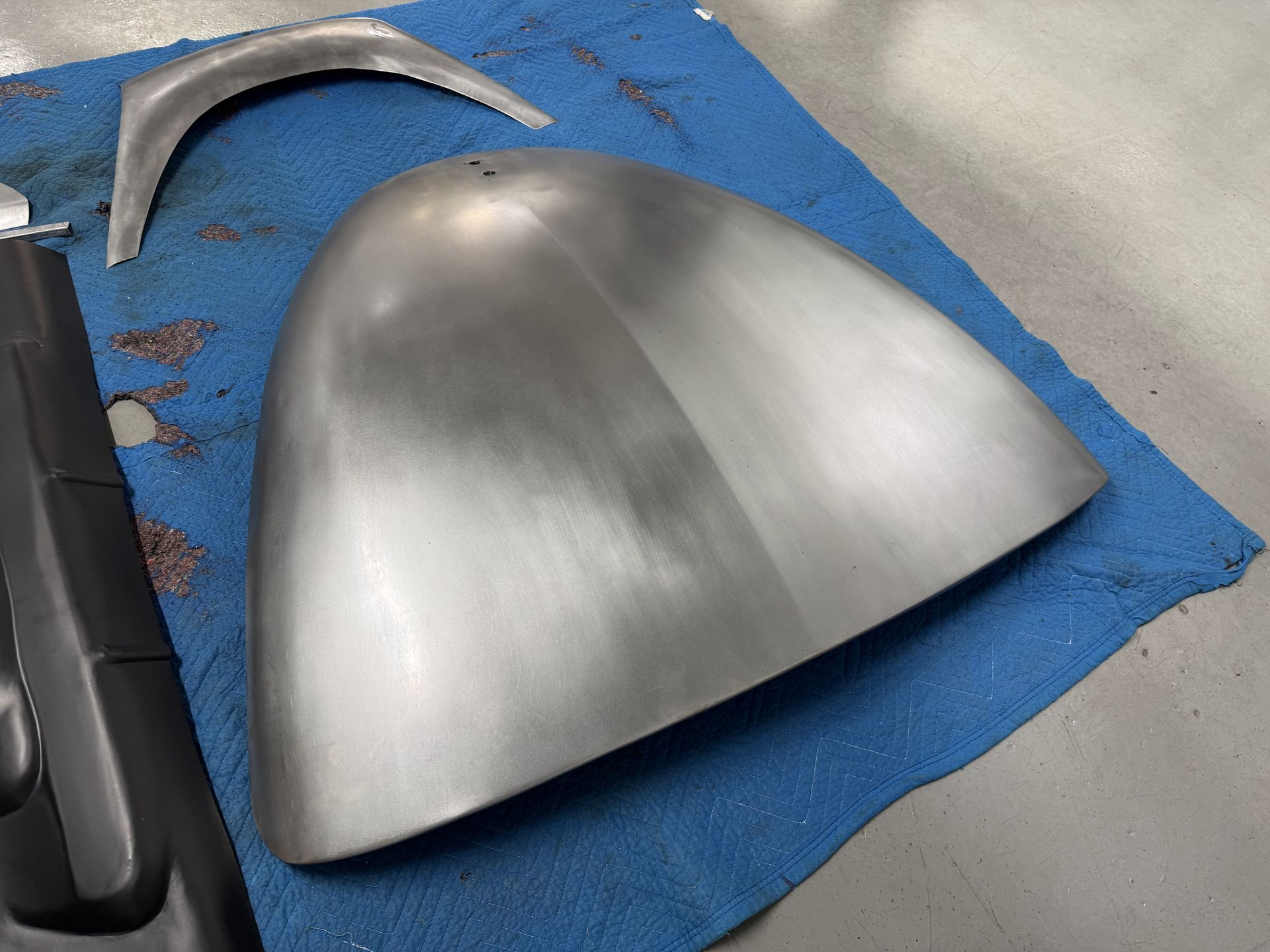 A metal object is laying on a blue cloth