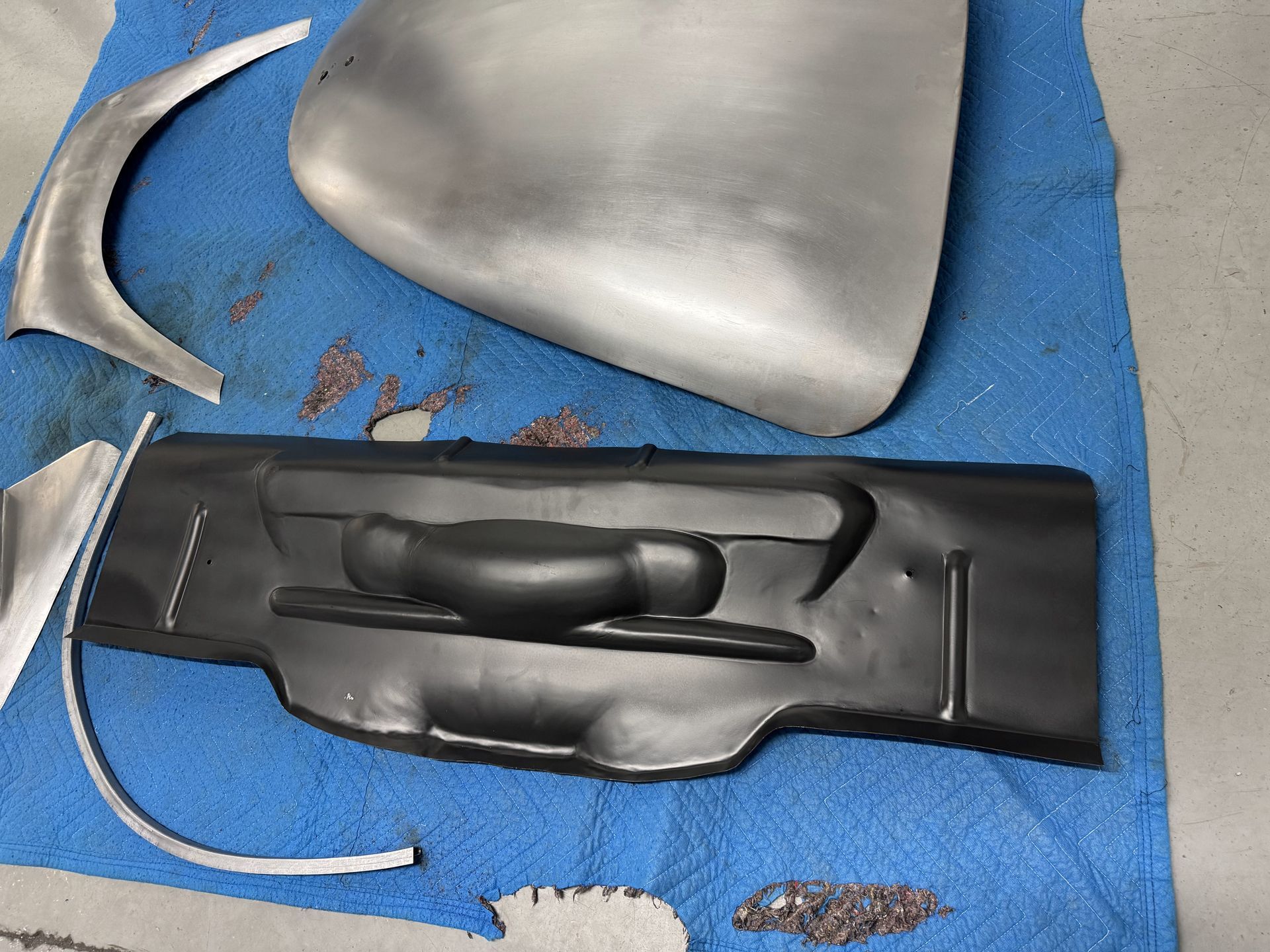 A piece of metal is laying on a blue cloth