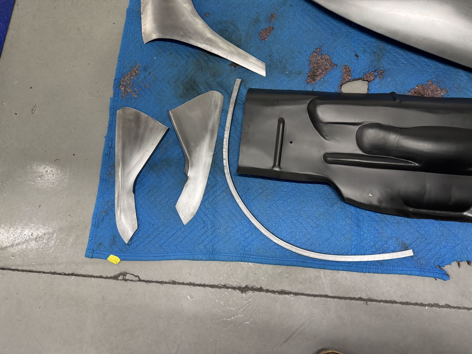 A piece of metal is laying on a blue cloth