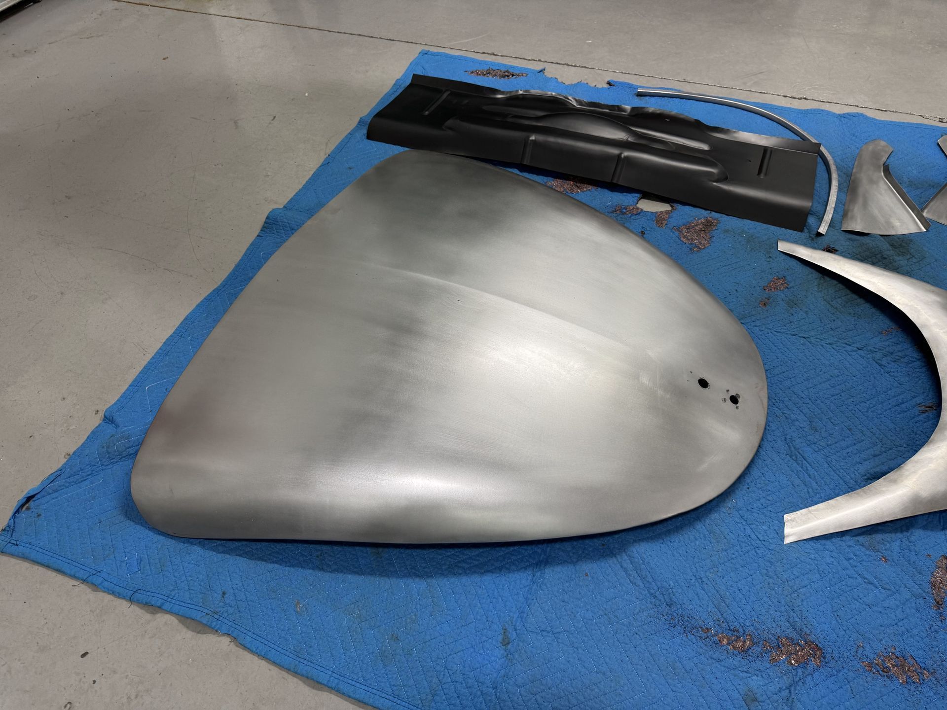 A piece of metal is laying on a blue cloth