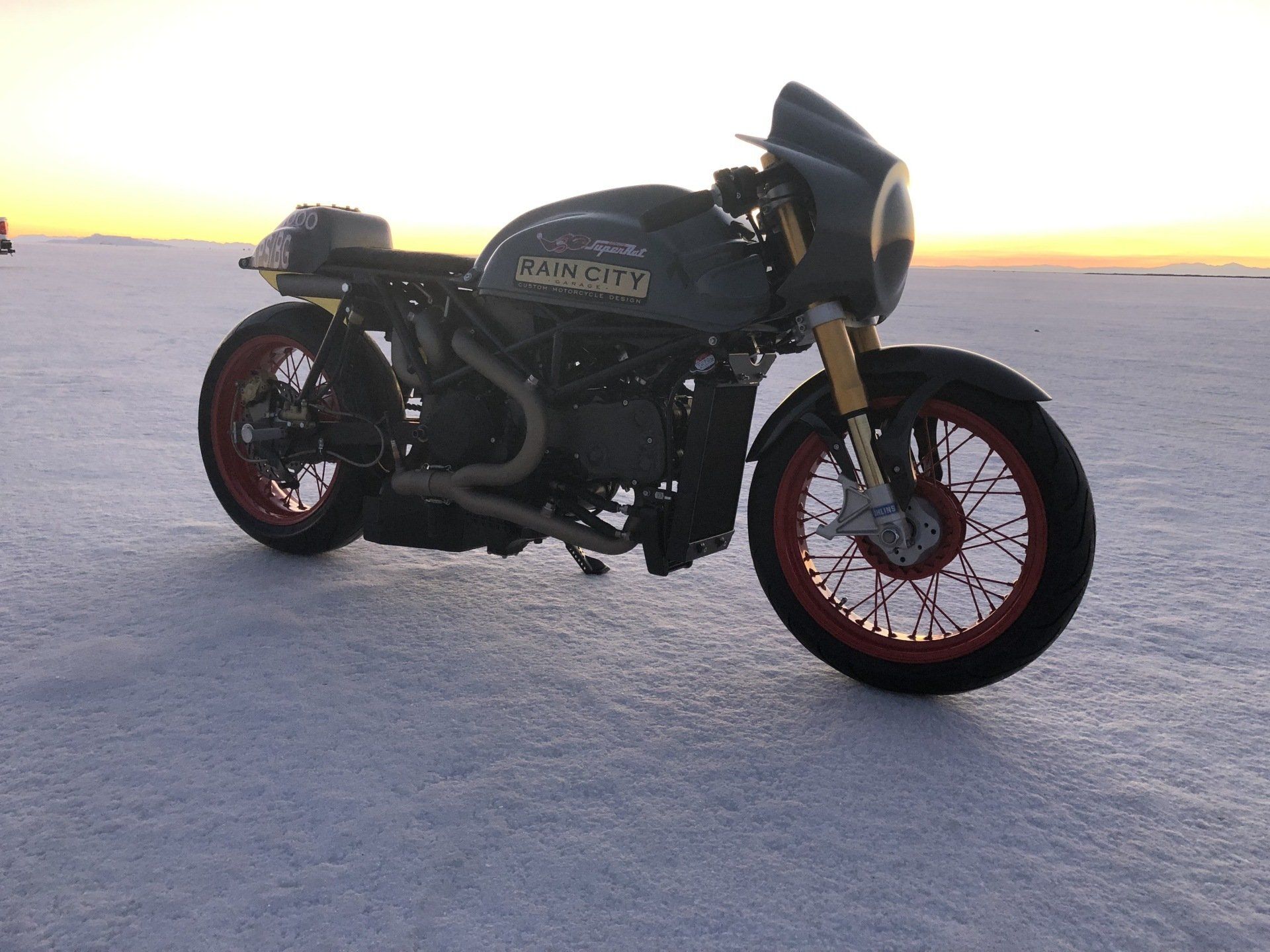 A motorcycle is parked on a snow covered field.