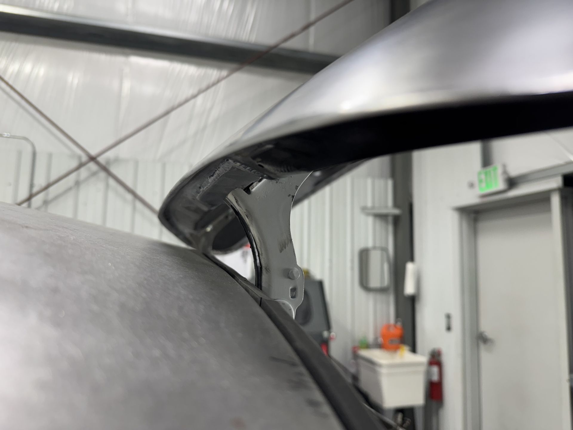 A close up of a car hood in a garage.