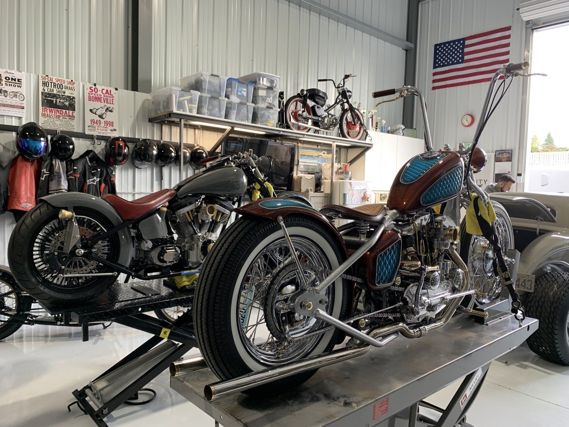 A motorcycle is sitting on a lift in a garage.