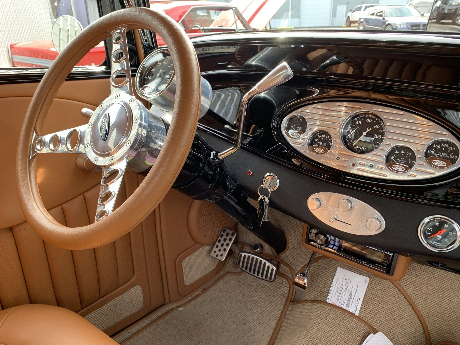 The inside of a car with a steering wheel and dashboard
