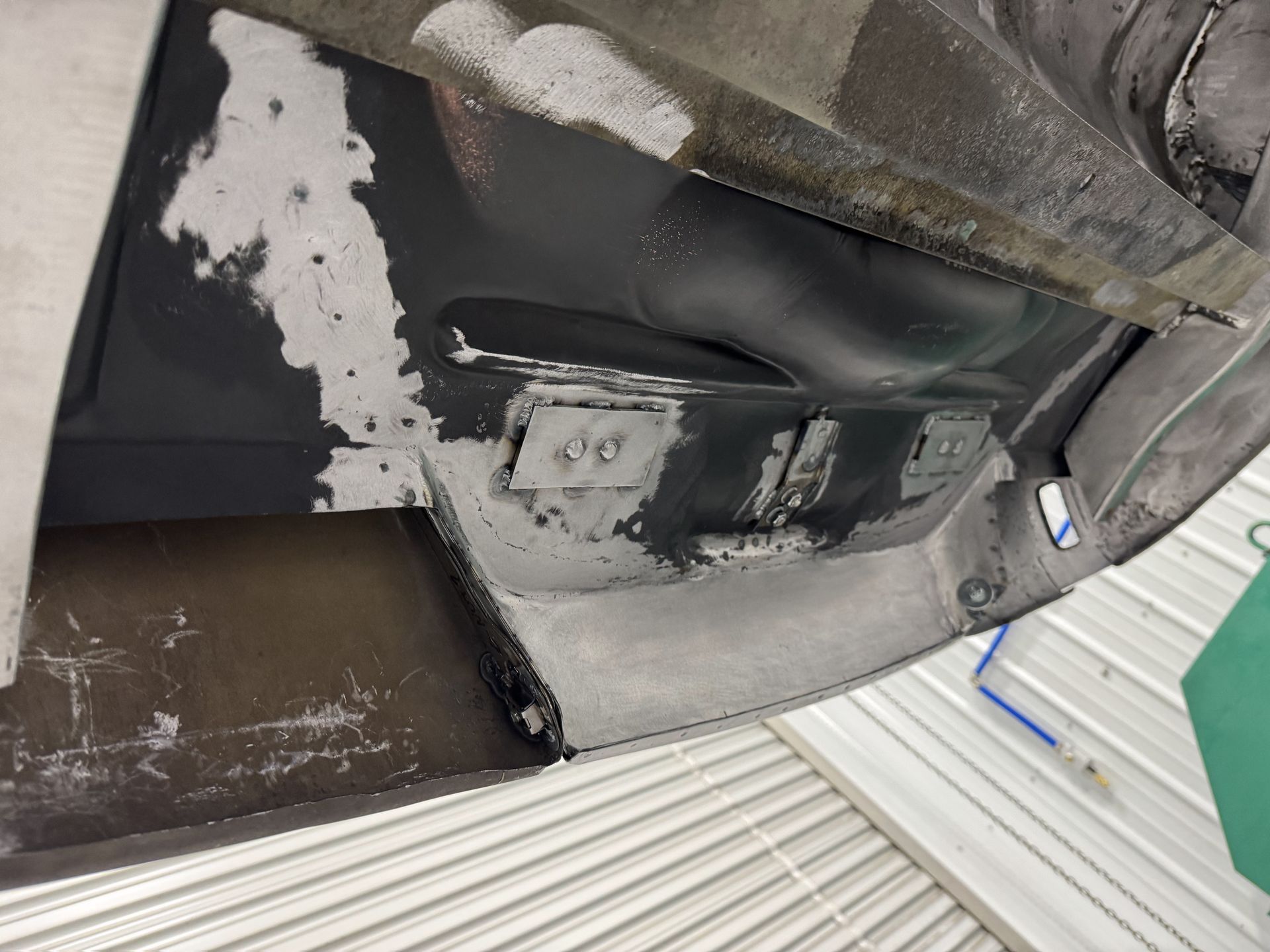 A close up of a piece of metal with peeling paint on it.