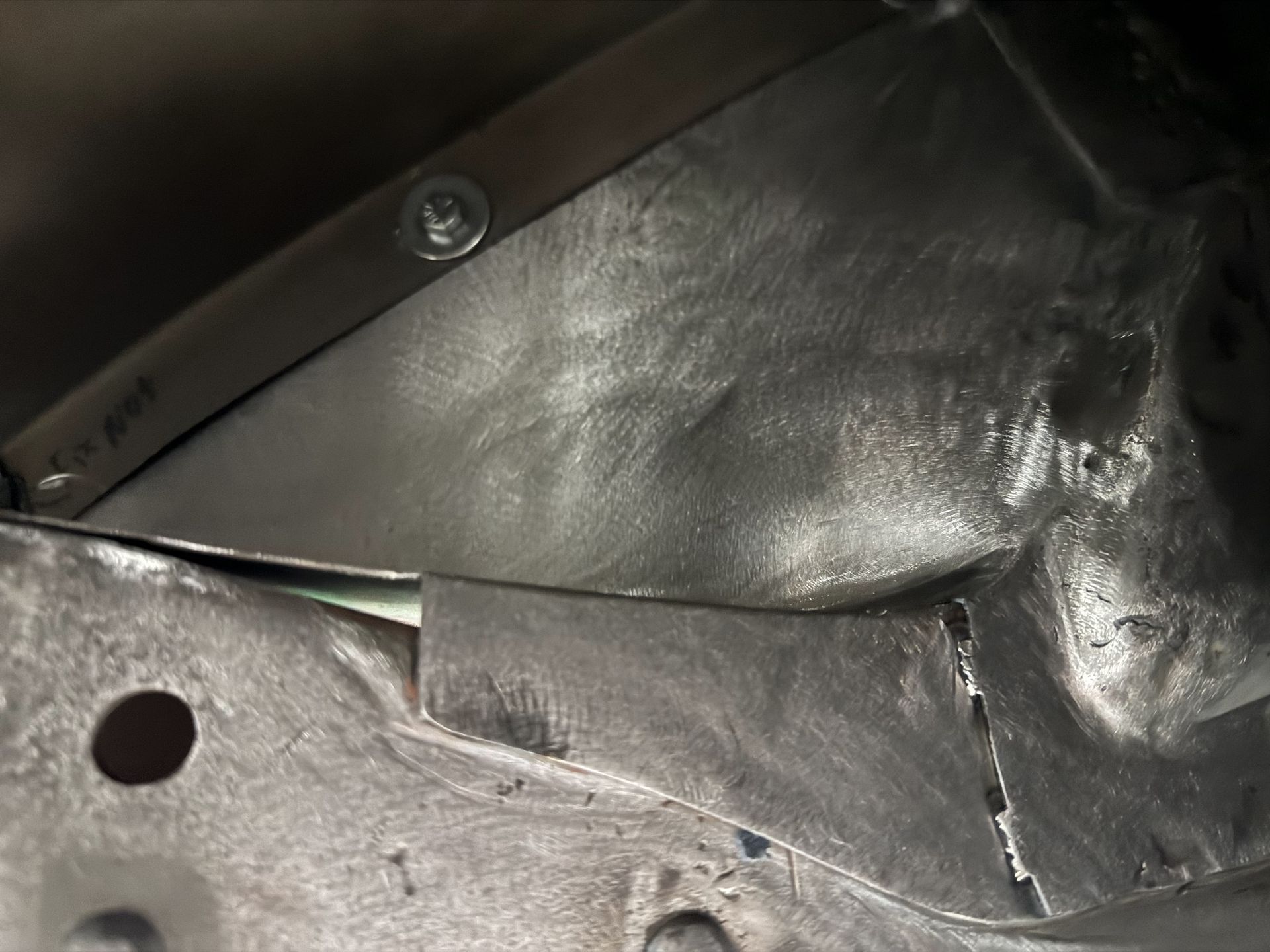 A close up of a piece of metal with holes in it.