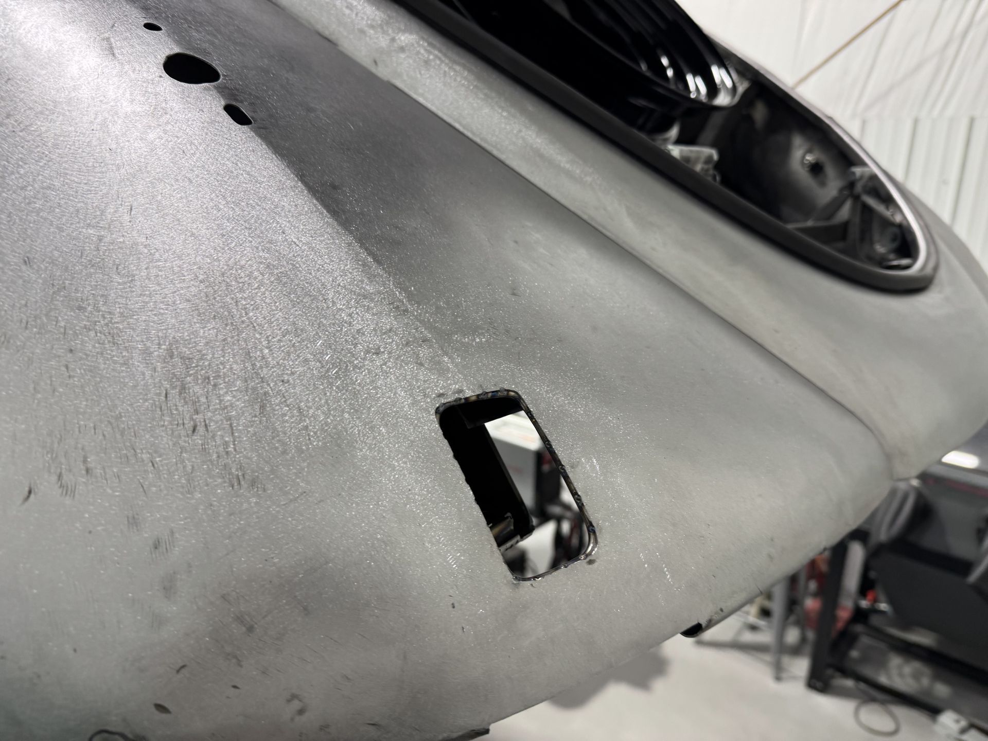 A close up of a car bumper with a hole in it