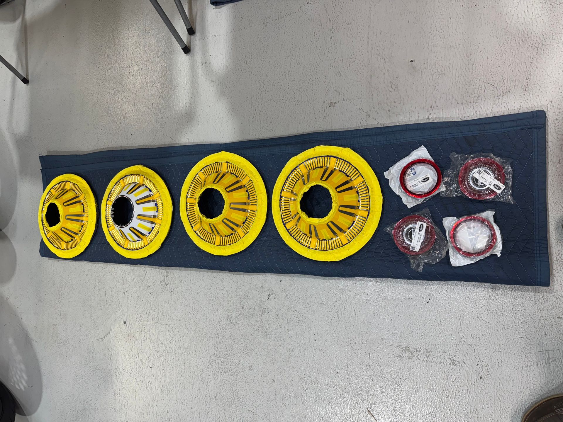 A row of yellow wheels on a blue cloth