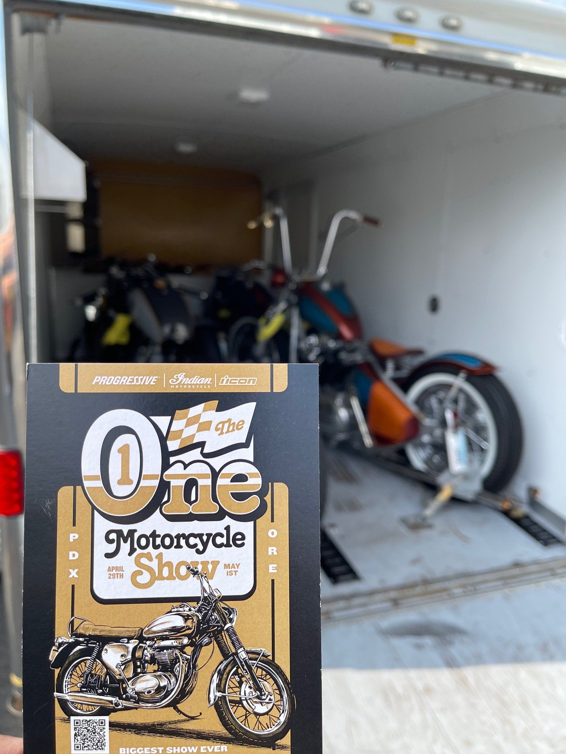 A book titled one motorcycle show with a motorcycle in the background