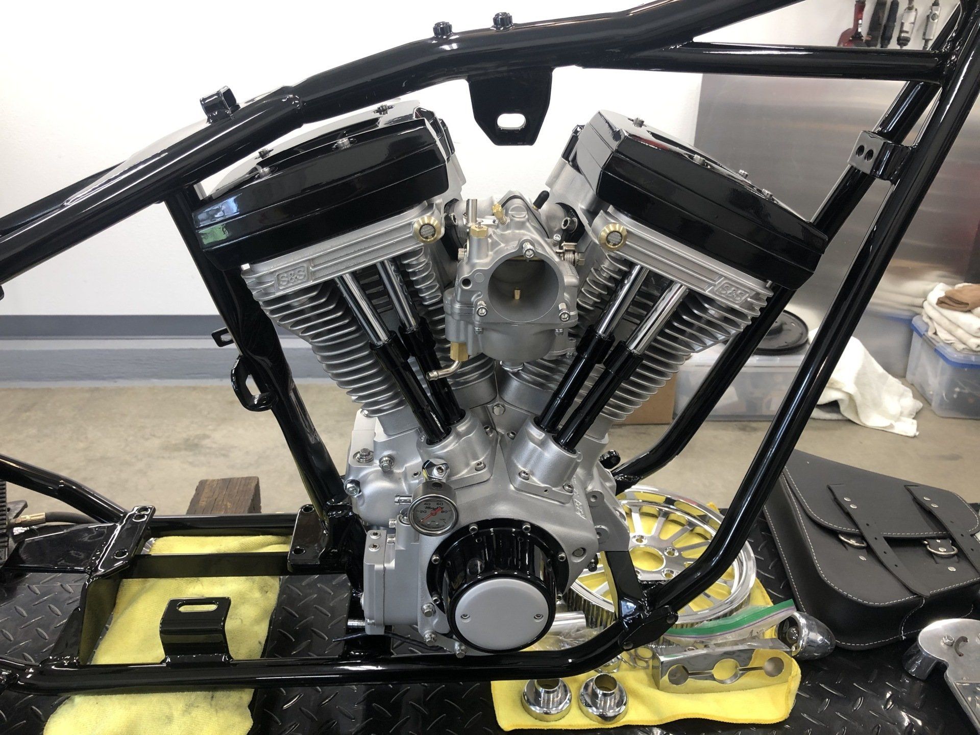 A motorcycle engine is sitting on top of a yellow towel on a table.