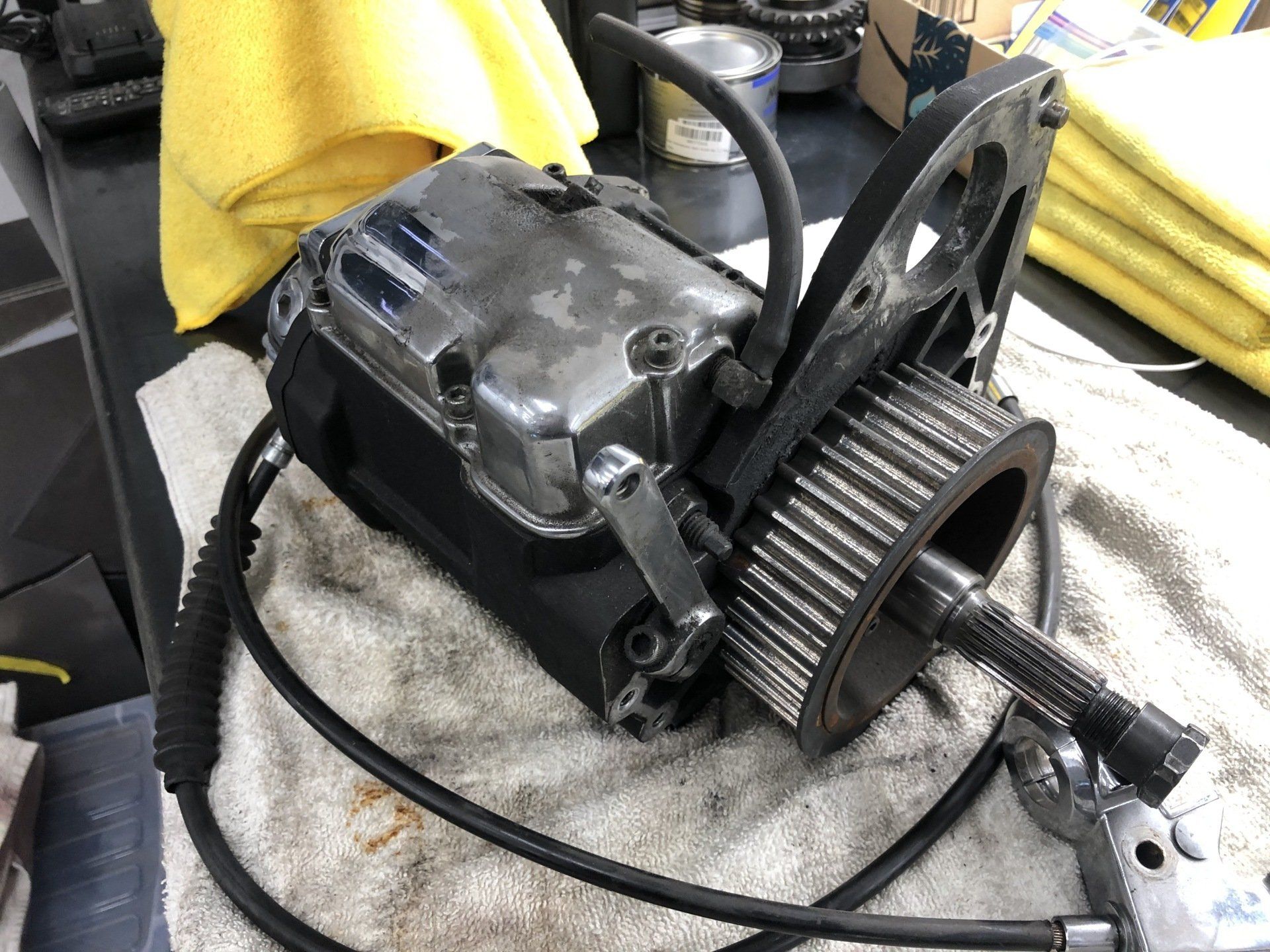 A motorcycle engine is sitting on a towel on a table.
