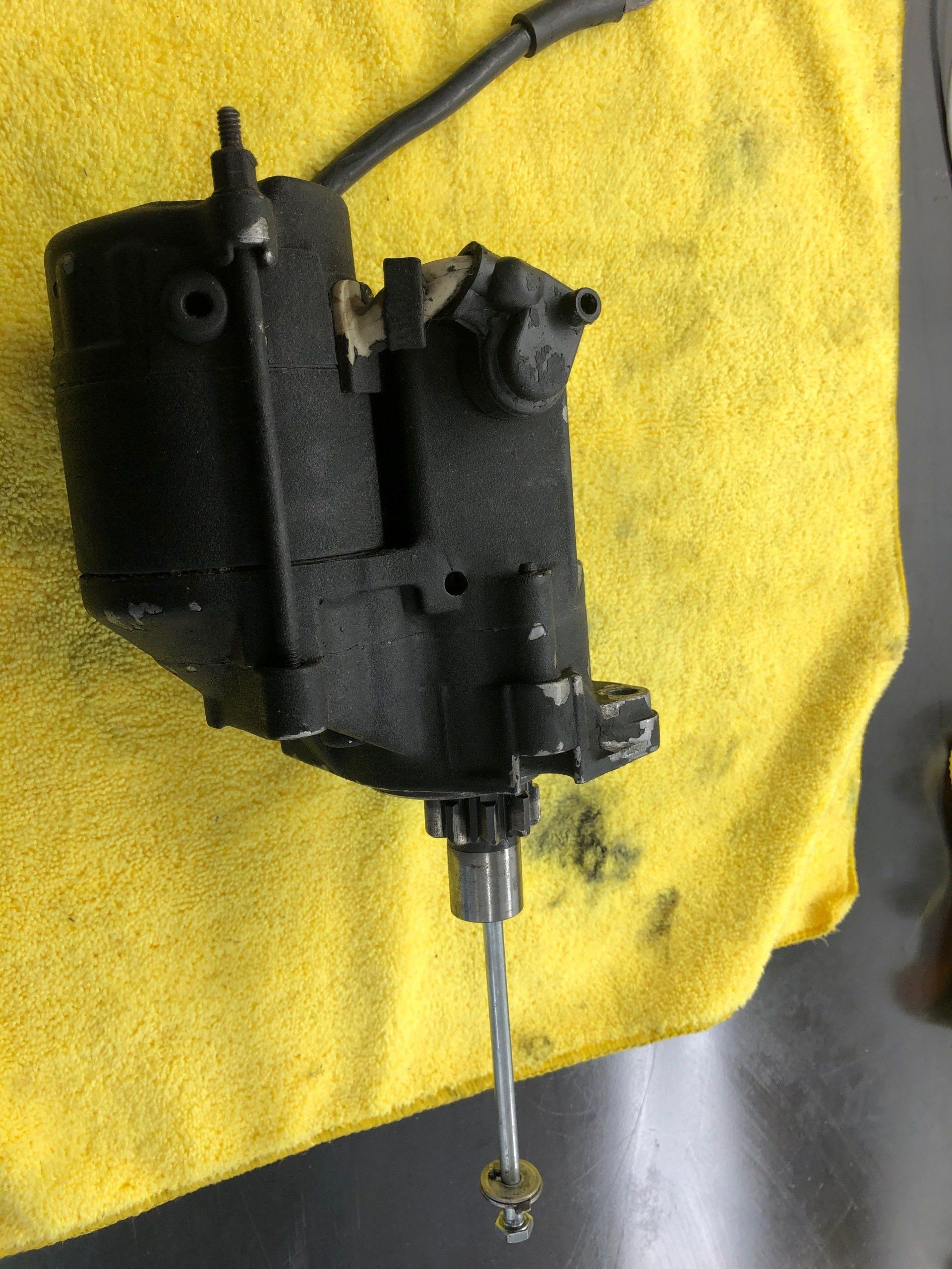 A black object is sitting on a yellow towel