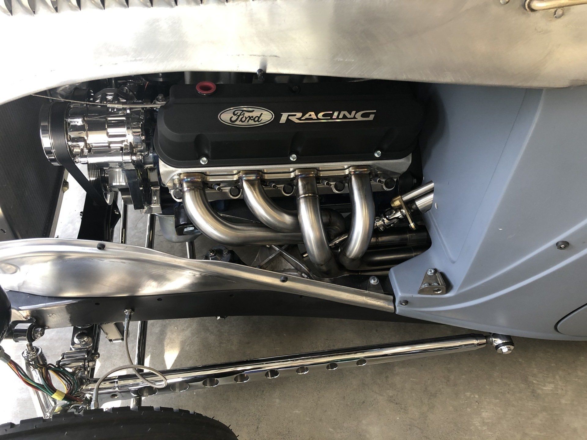 A close up of a ford racing engine in a car
