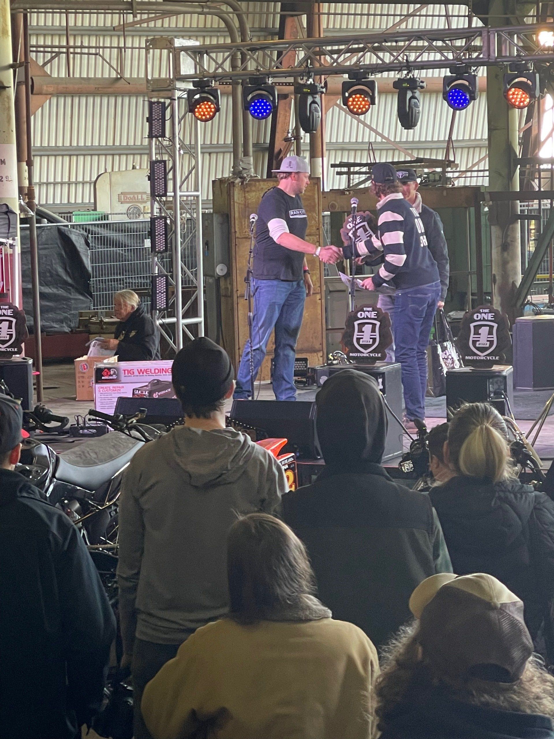 A group of people sitting in front of a stage