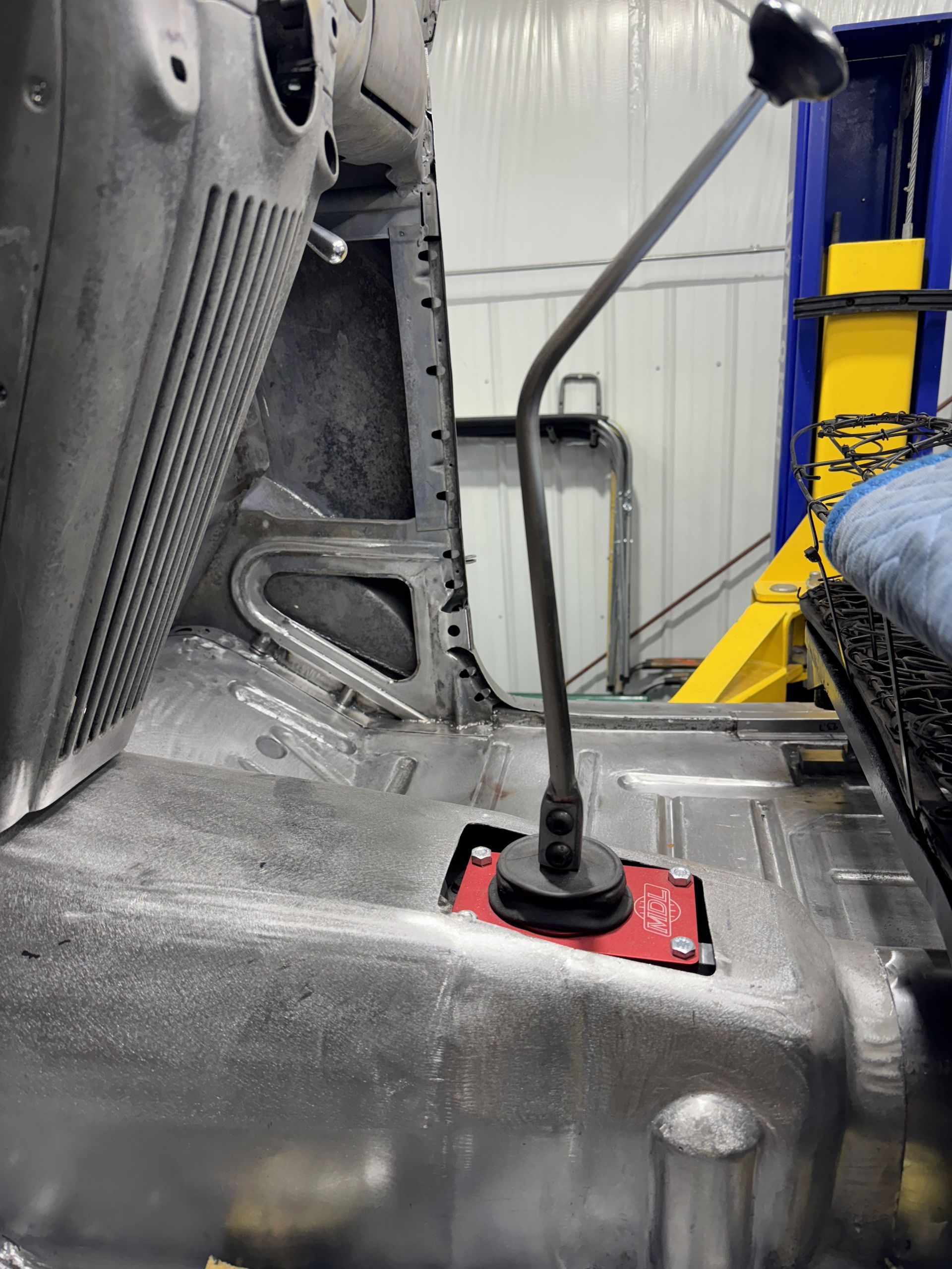 A microphone is sitting on top of a car in a garage.