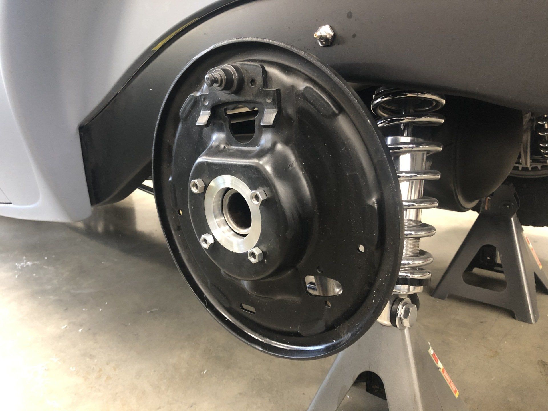 A close up of a car 's rear wheel on a jack.