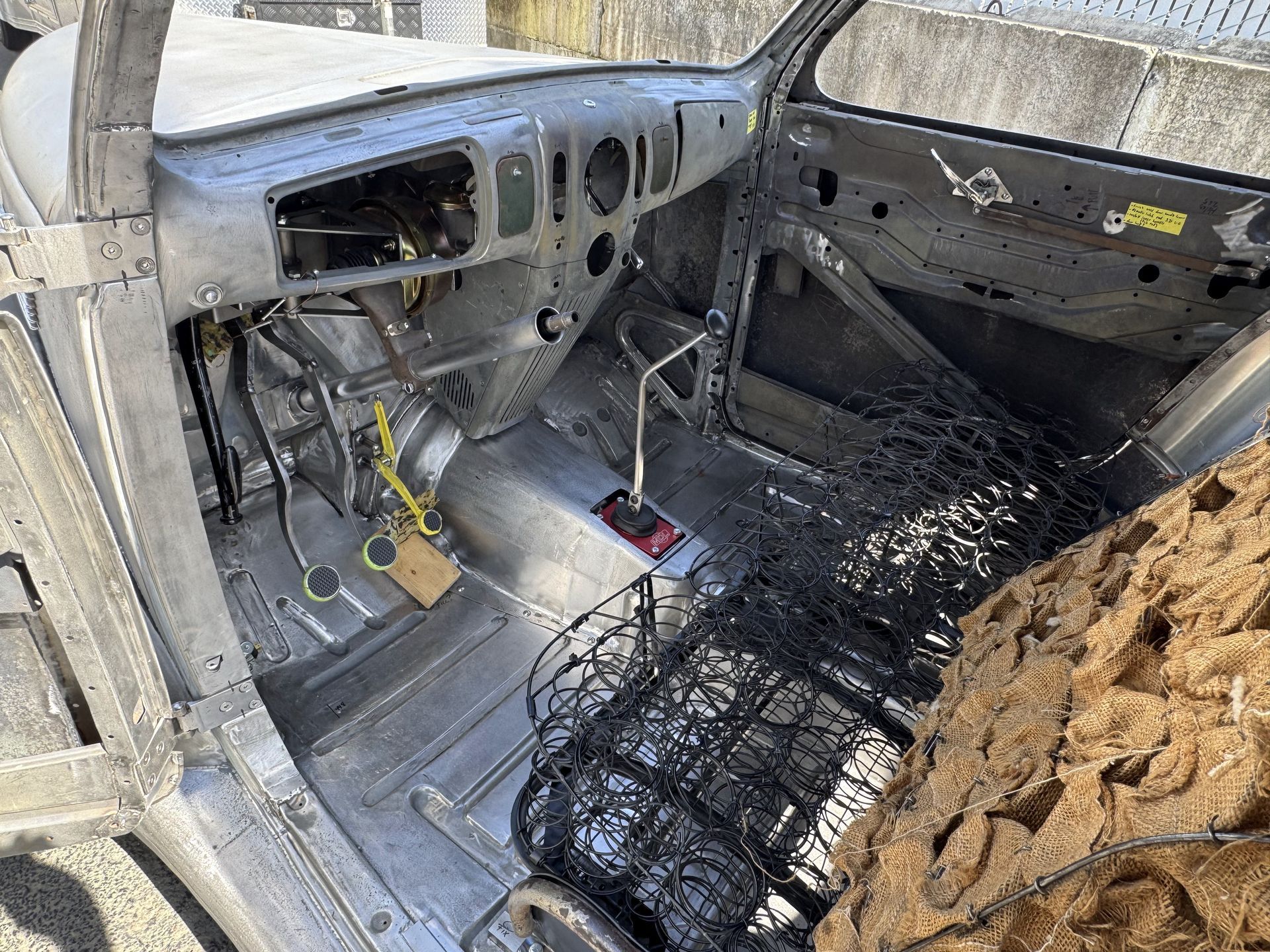 The inside of a car that is being built.