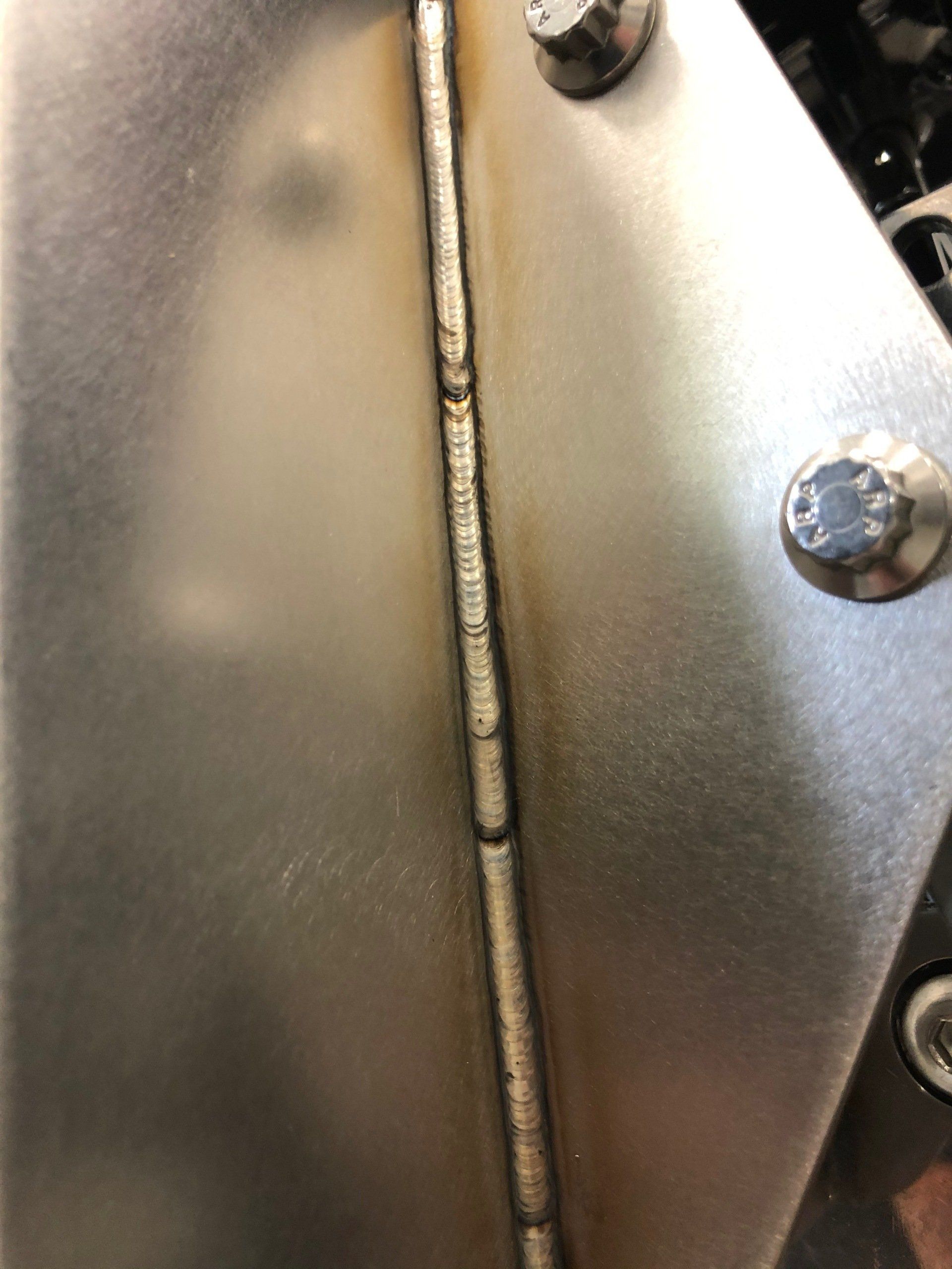 A close up of a welding joint on a metal surface.