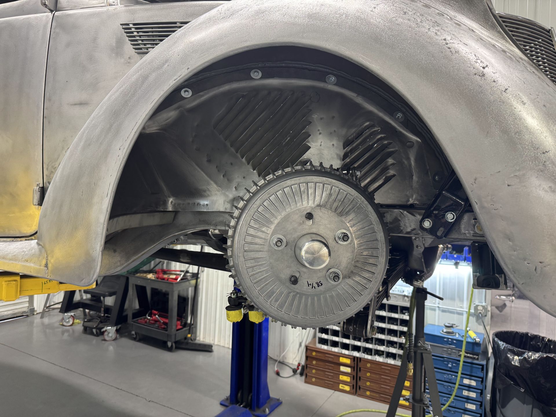 A car is sitting on a lift in a garage