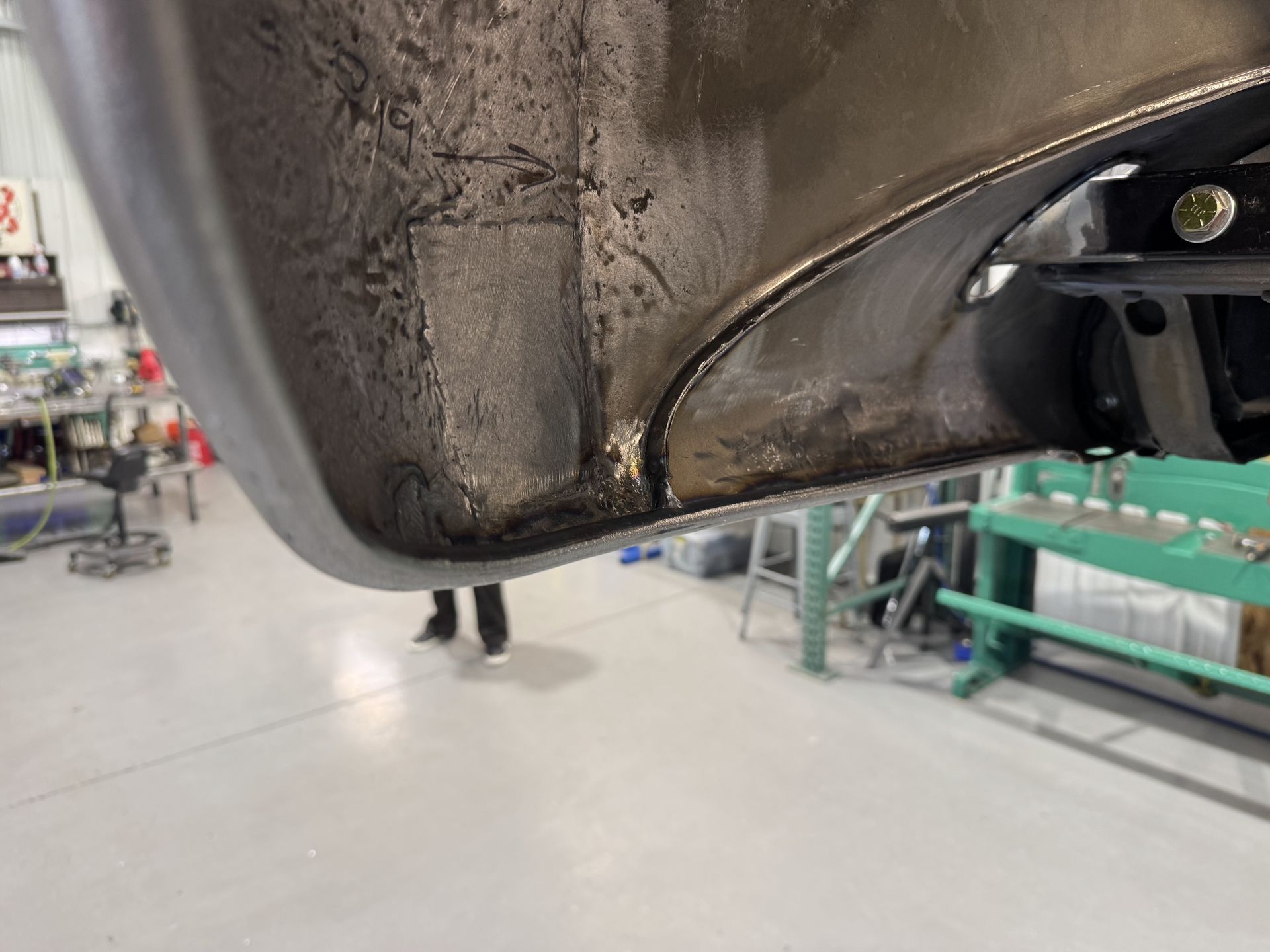 A close up of a car fender in a garage