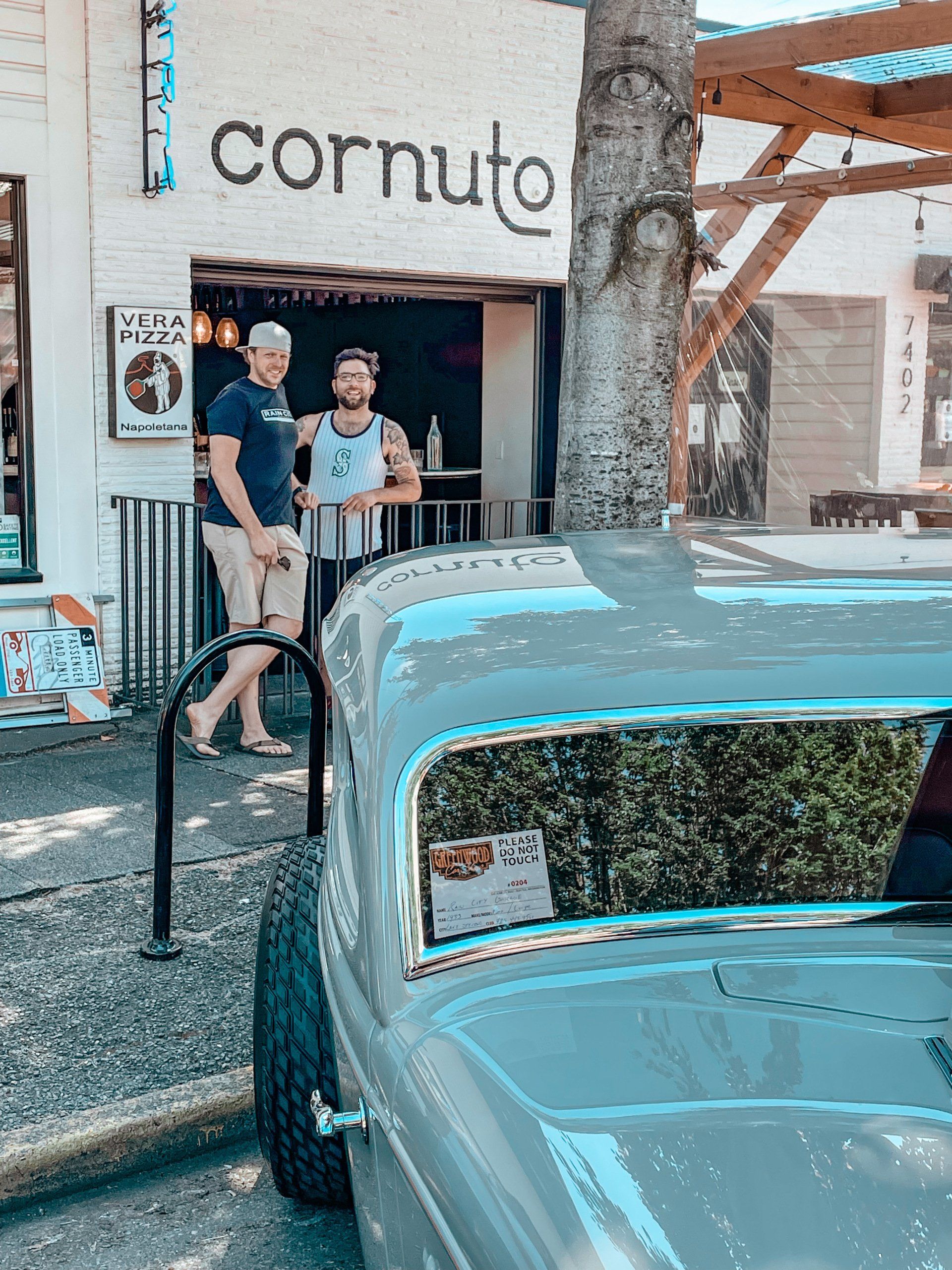 A car is parked in front of a cornuto restaurant.