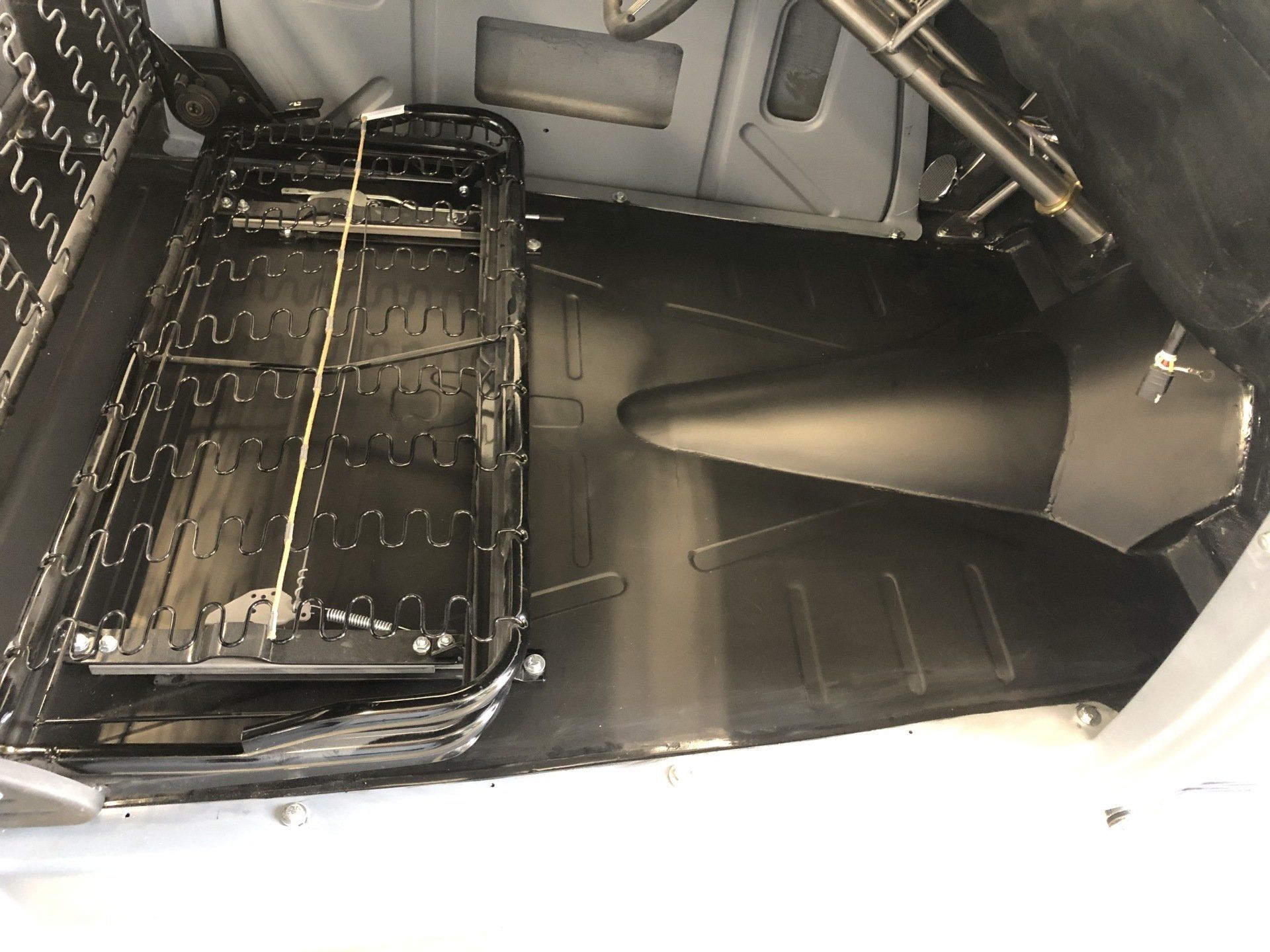 The inside of a car with a seat in it