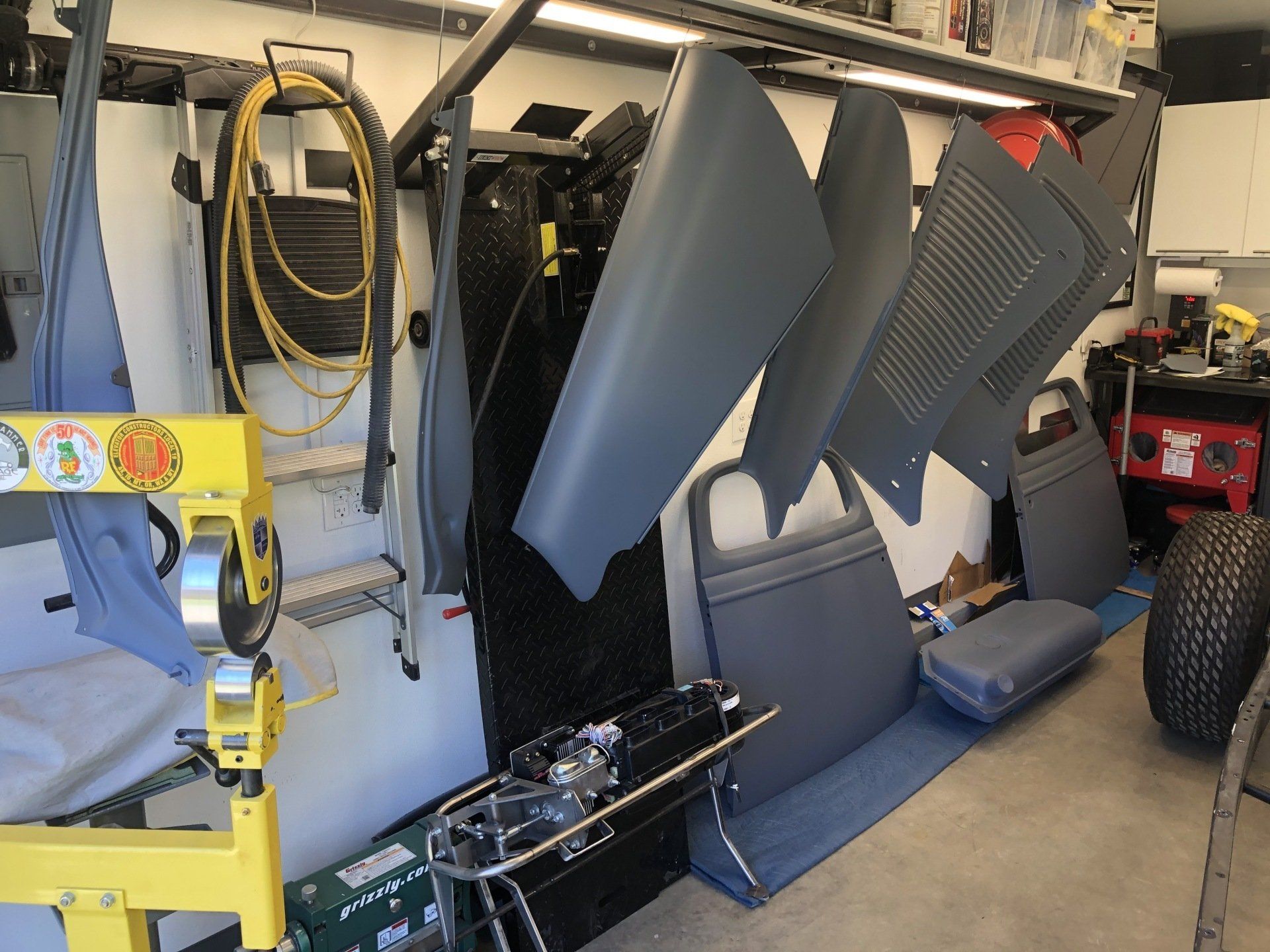 A garage filled with lots of gray pieces of furniture