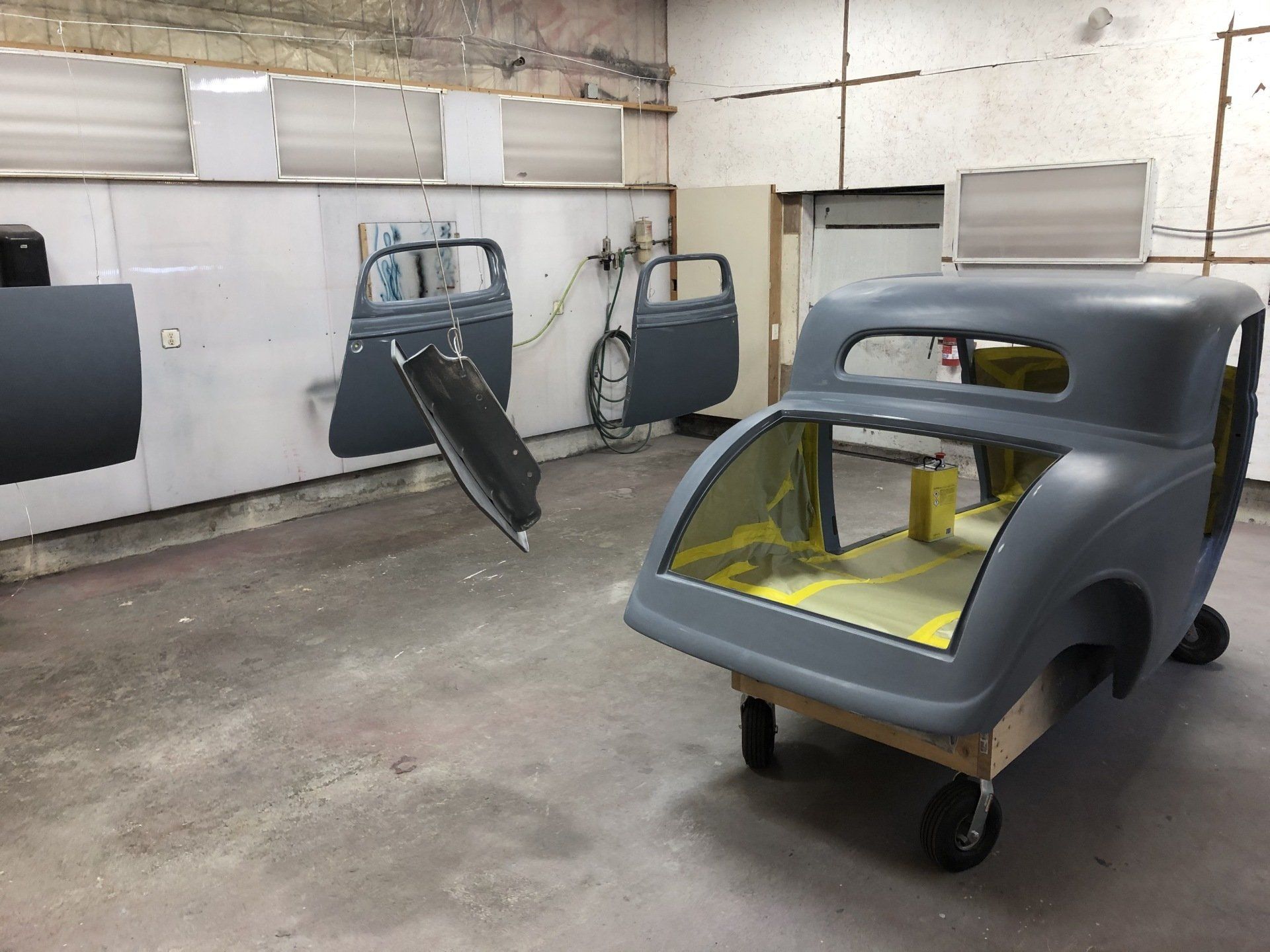 A car that is being painted in a garage