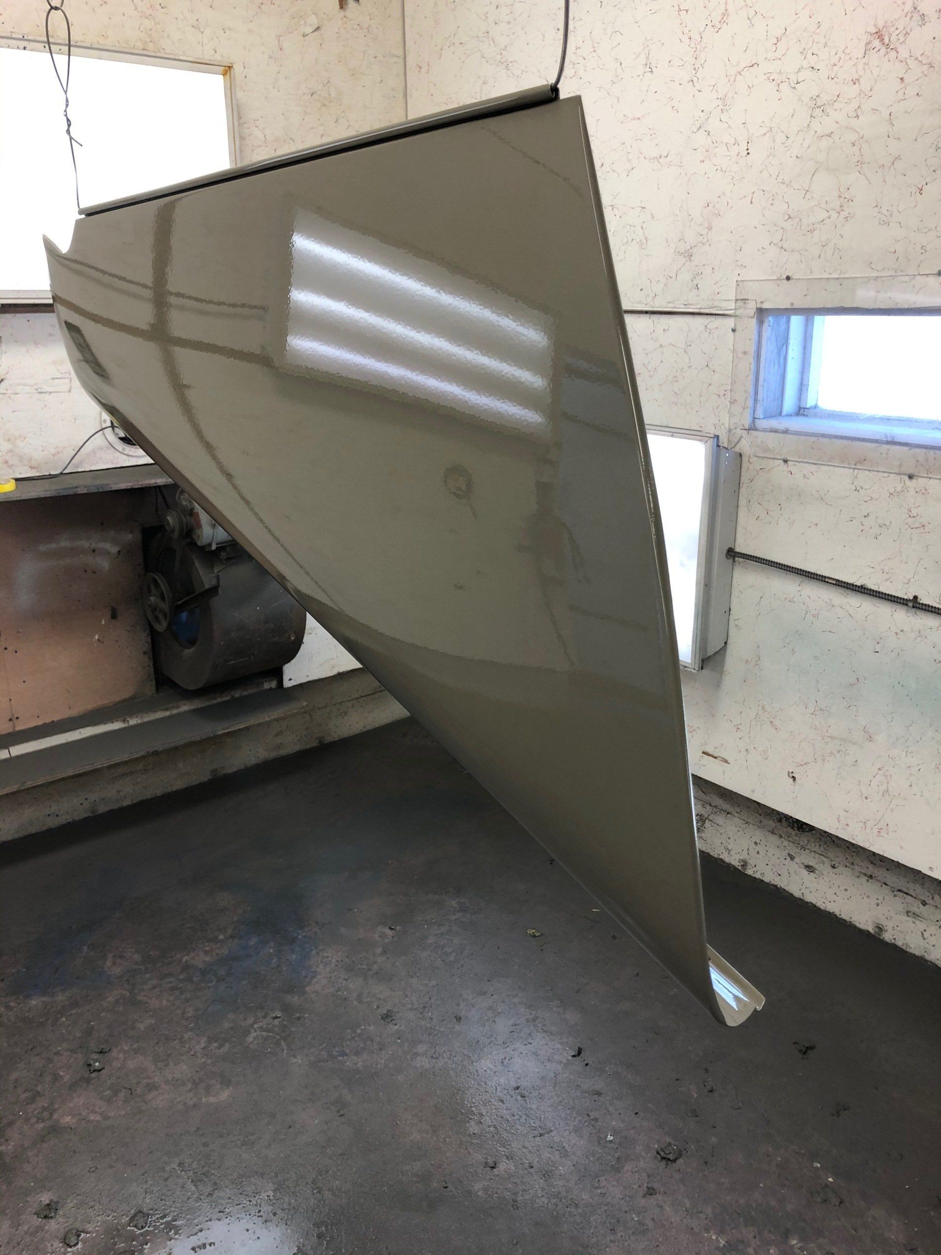 A piece of metal is hanging from the ceiling in a room.