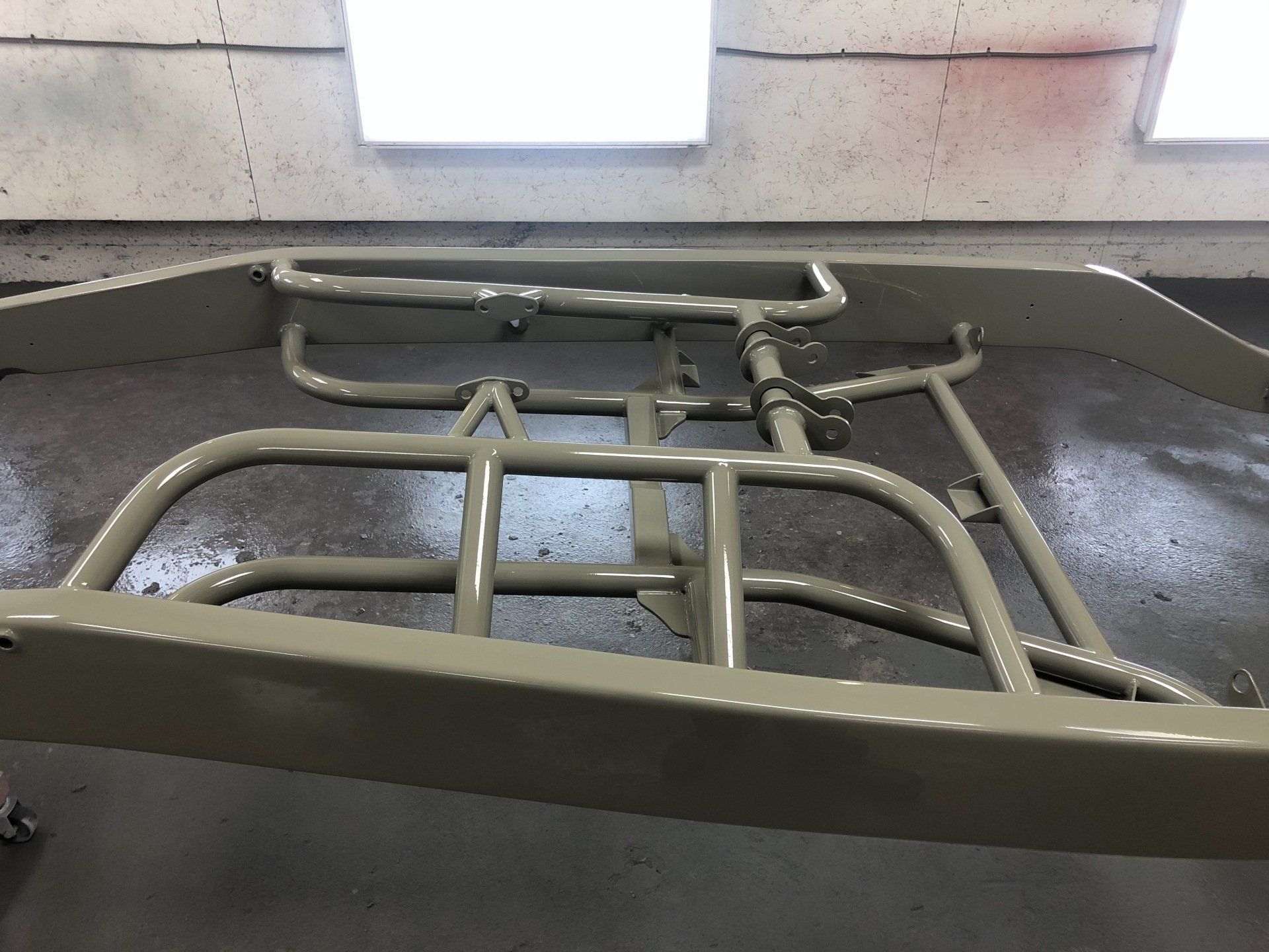 A piece of metal is sitting on the floor in a room.