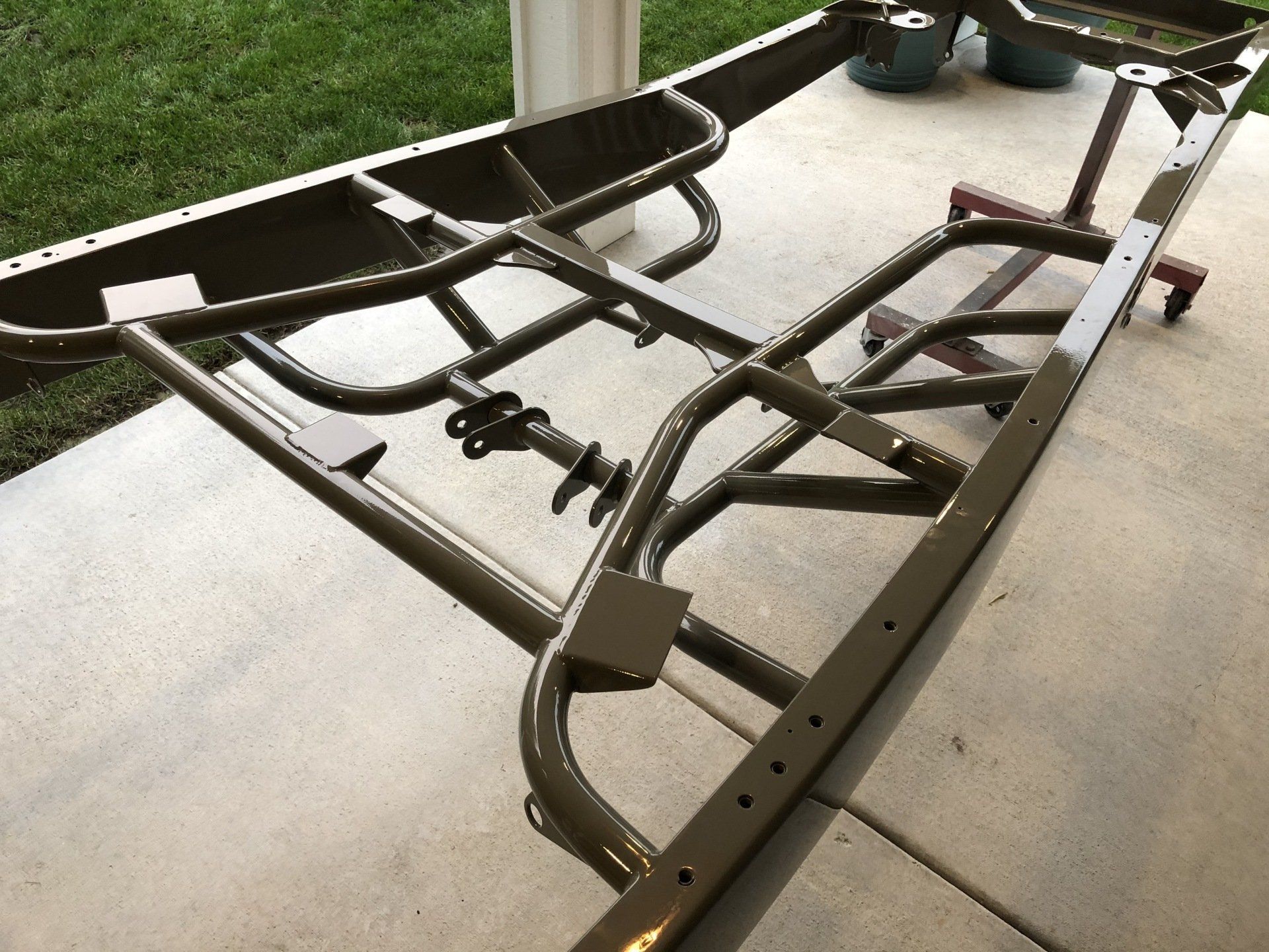 A metal frame is sitting on a concrete surface