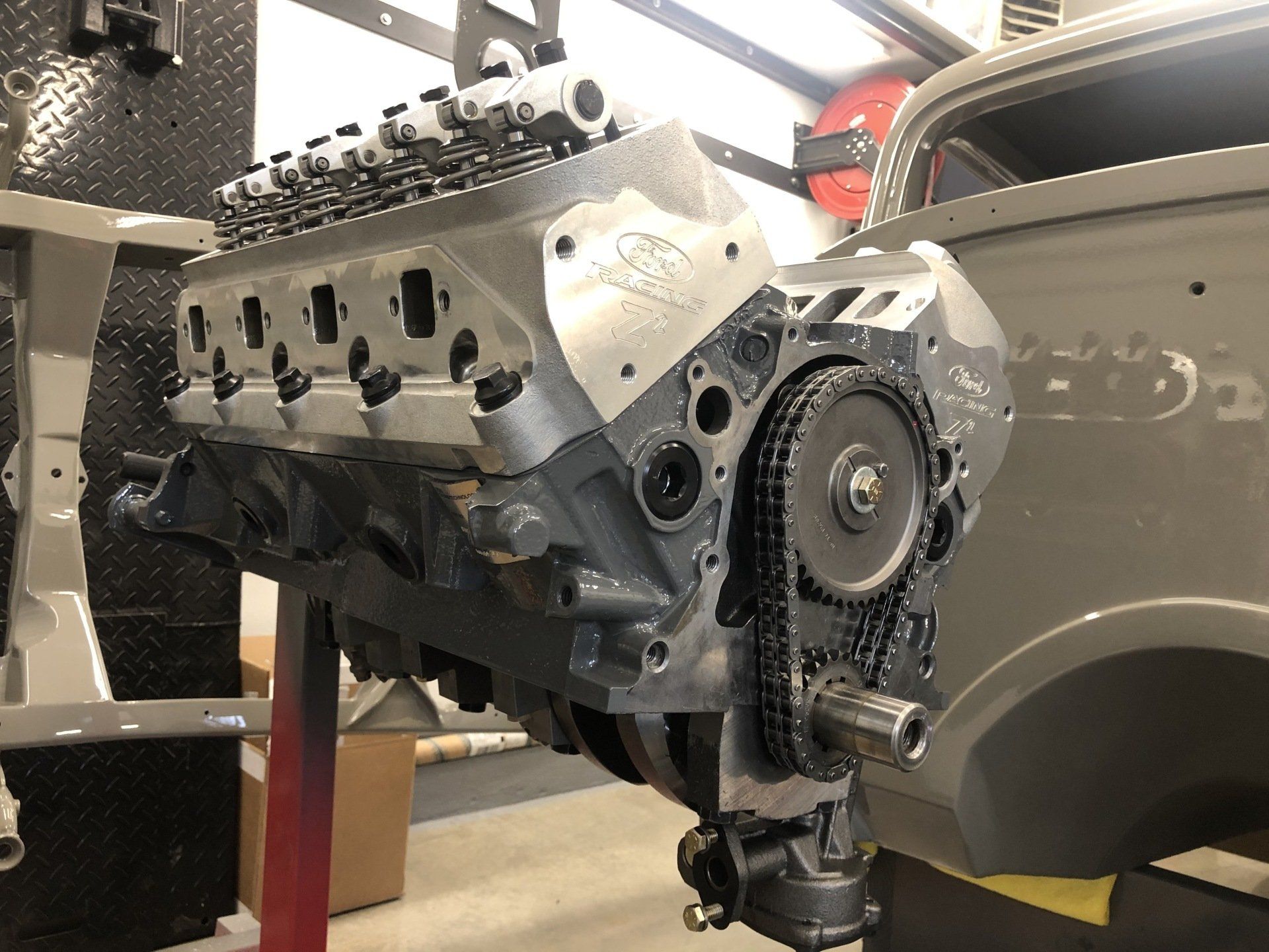 A close up of a car engine with a chain attached to it