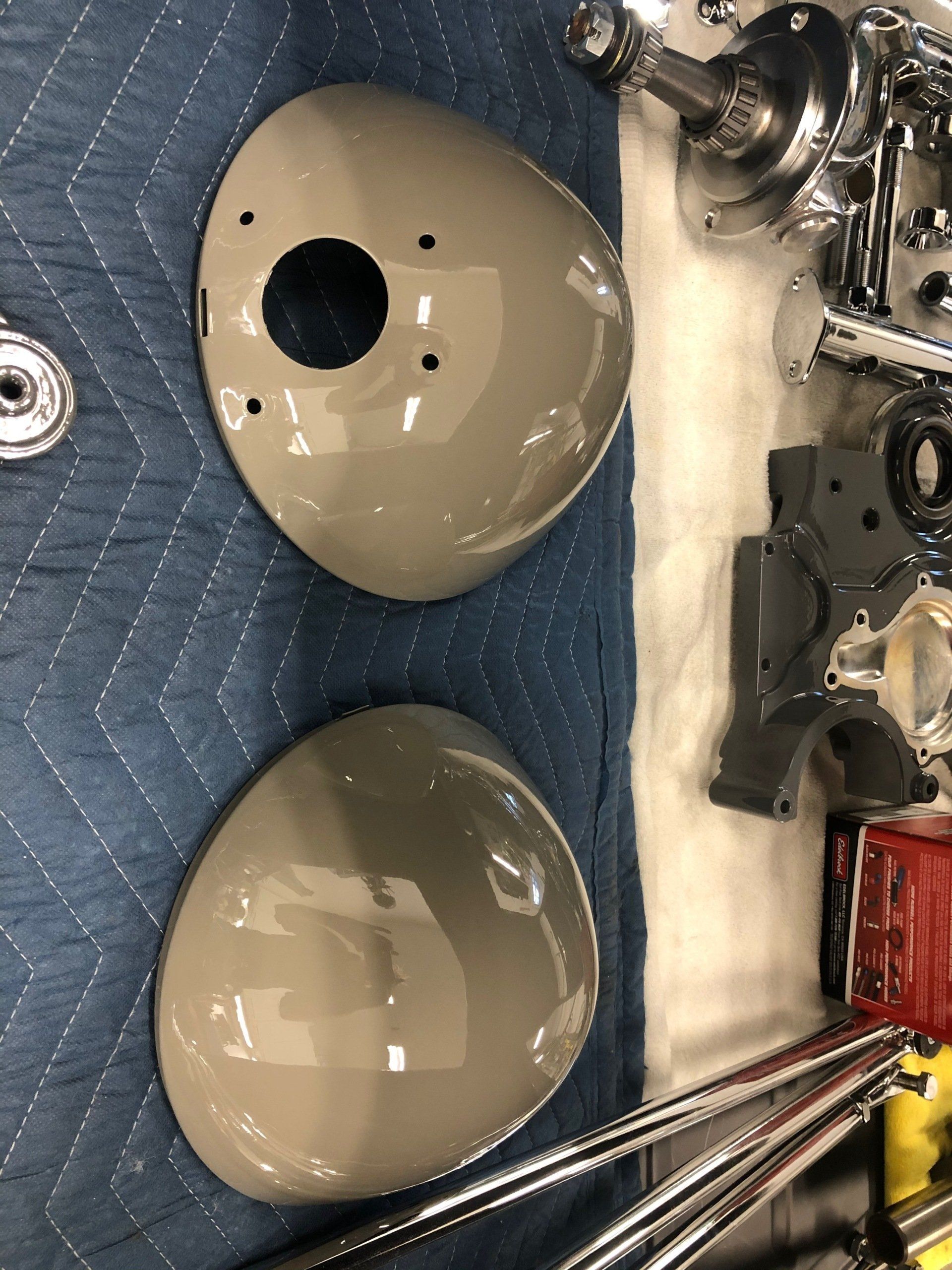 A pair of headlights are sitting on top of a blue blanket.