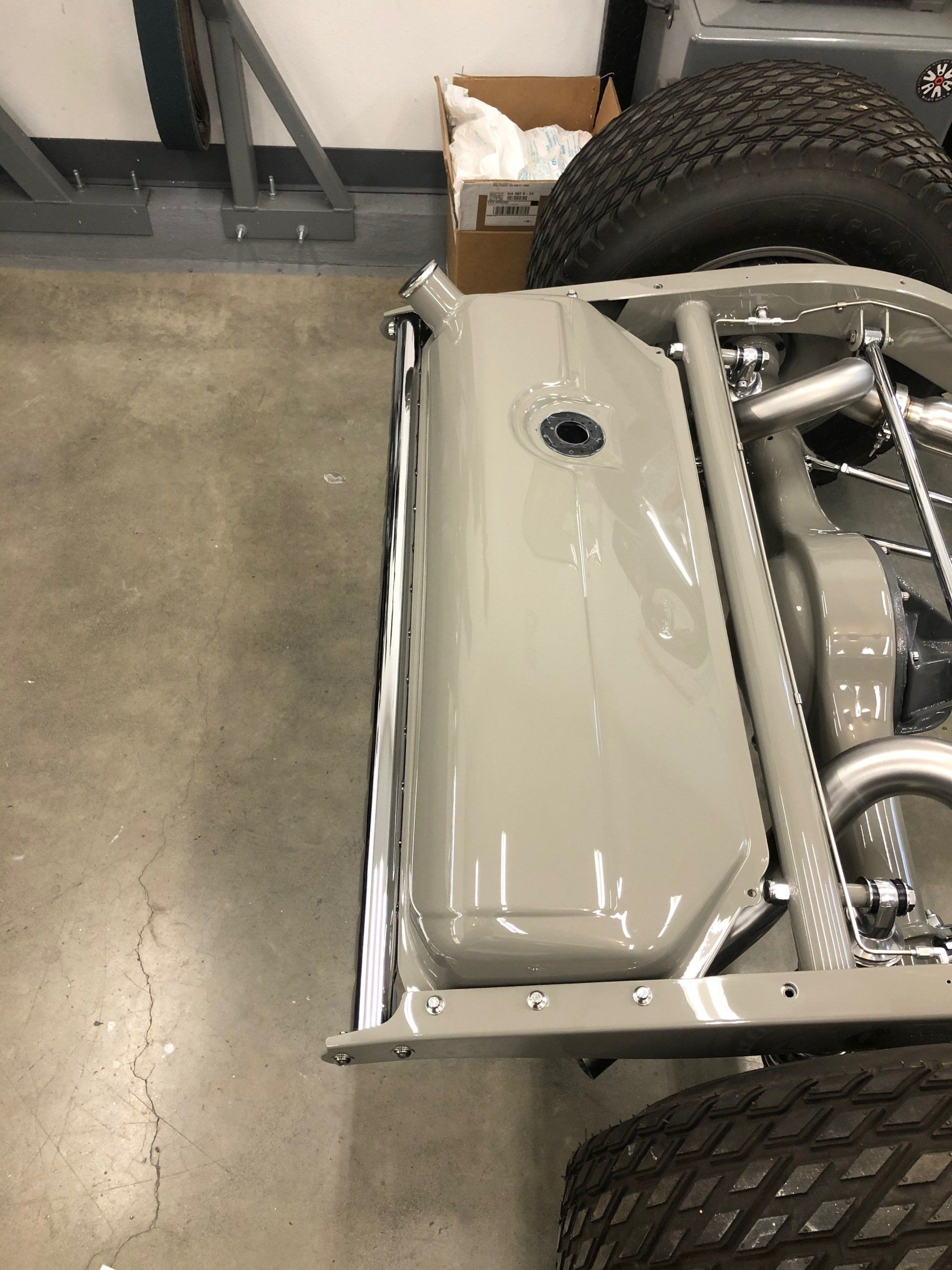 A car is sitting on a concrete floor in a garage.